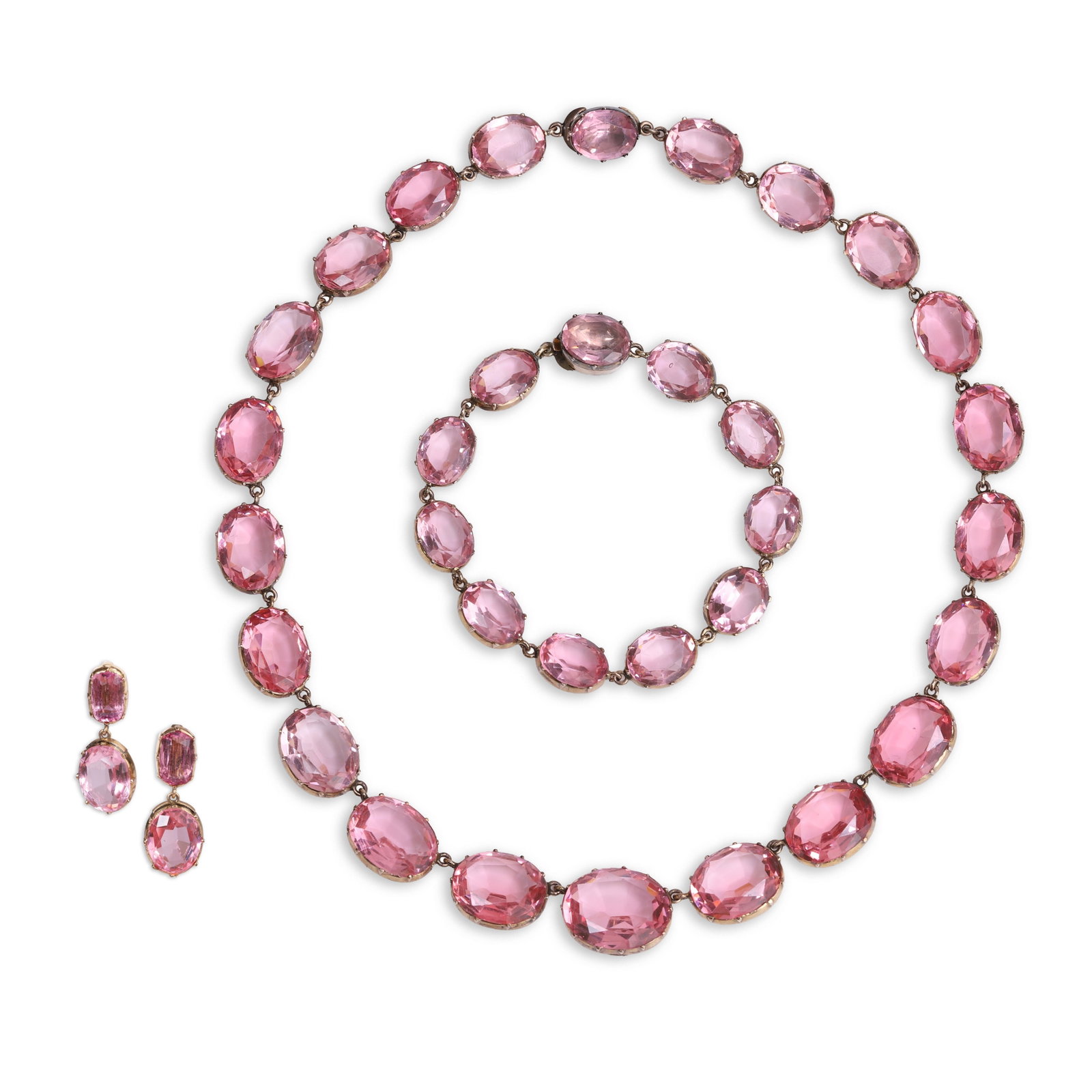 An antique pink paste demi parure,: An antique pink paste demi parure, comprising a rivière necklace of twenty two graduated oval pink pastes set to cut-down collets with stone set box clasp and a matching bracelet of eleven paste 