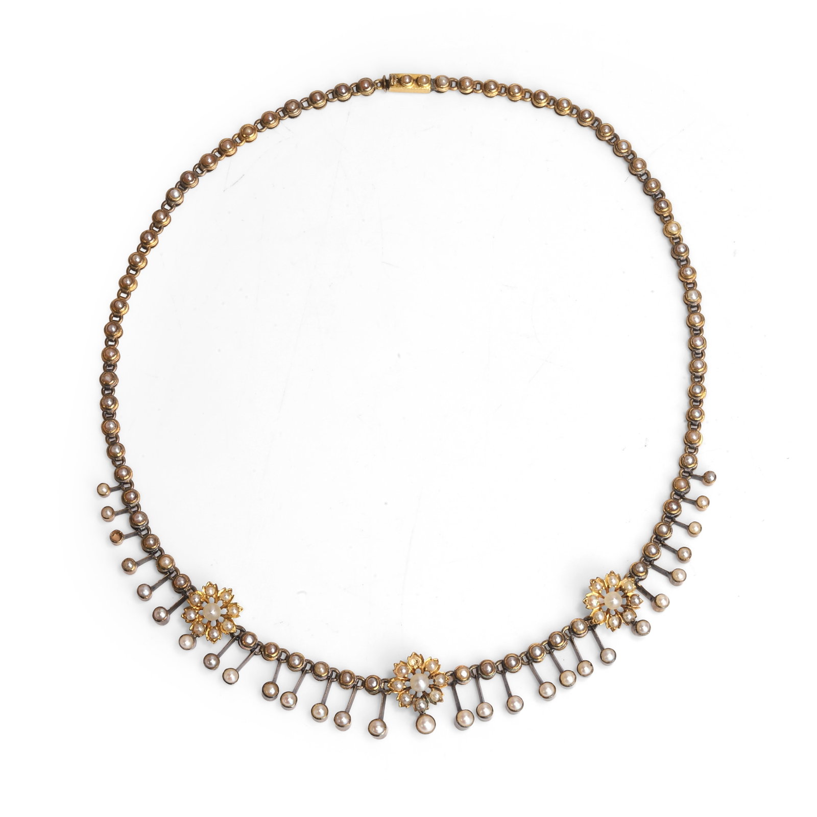 A late Victorian seed pearl fringe necklace,: A late Victorian seed pearl fringe necklace, the centrepiece comprising a graduated fringe, interspersed with three seed pearl-set flower motifs, leading to an articulated seed pearl necklace and a bo