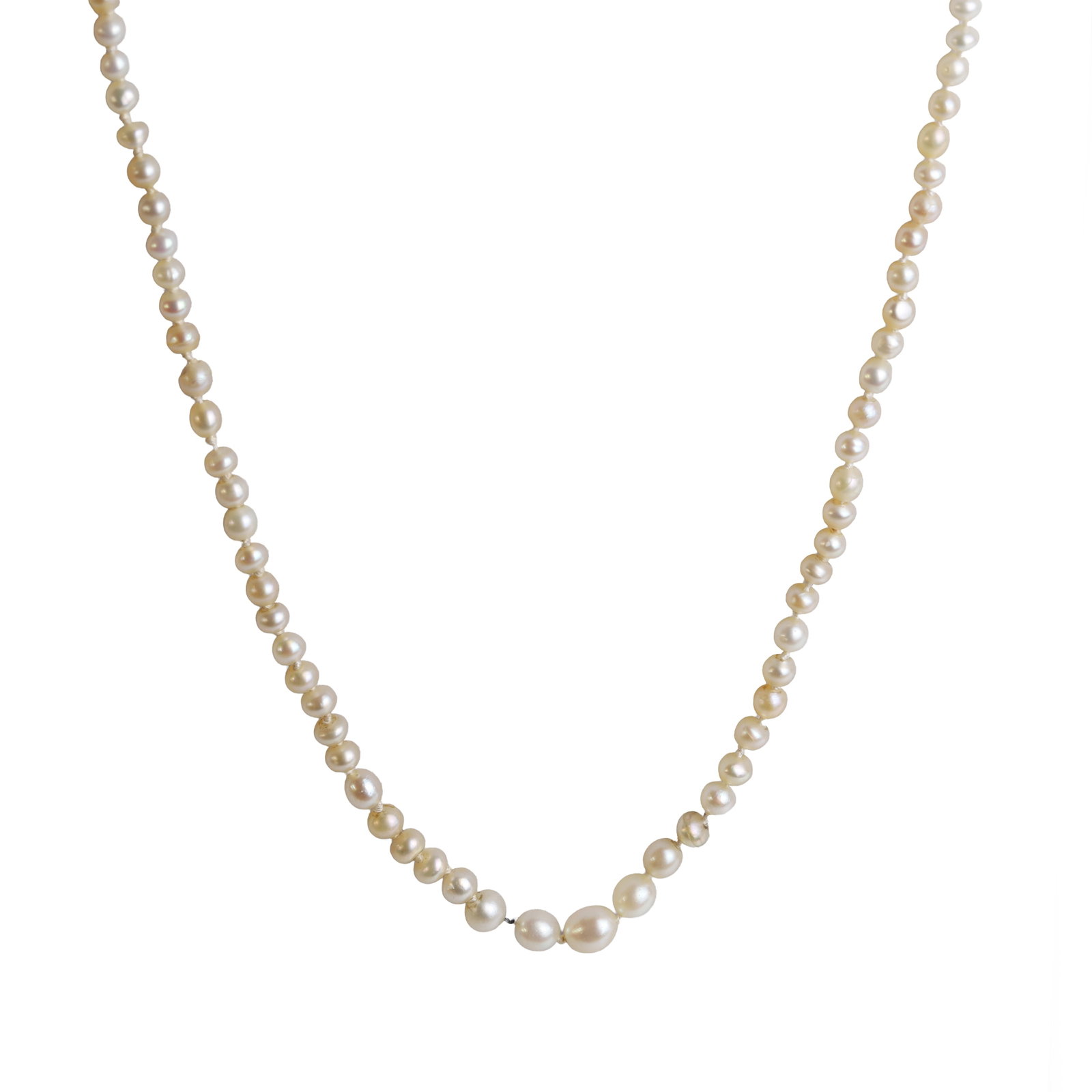 A natural saltwater pearl necklace,: A natural saltwater pearl necklace, comprising a single row of graduated off-round natural pearls, approximately 3.00mm to 5.50mm, strung knotted to a barrel clasp stamped 9ct. Includes one small bead