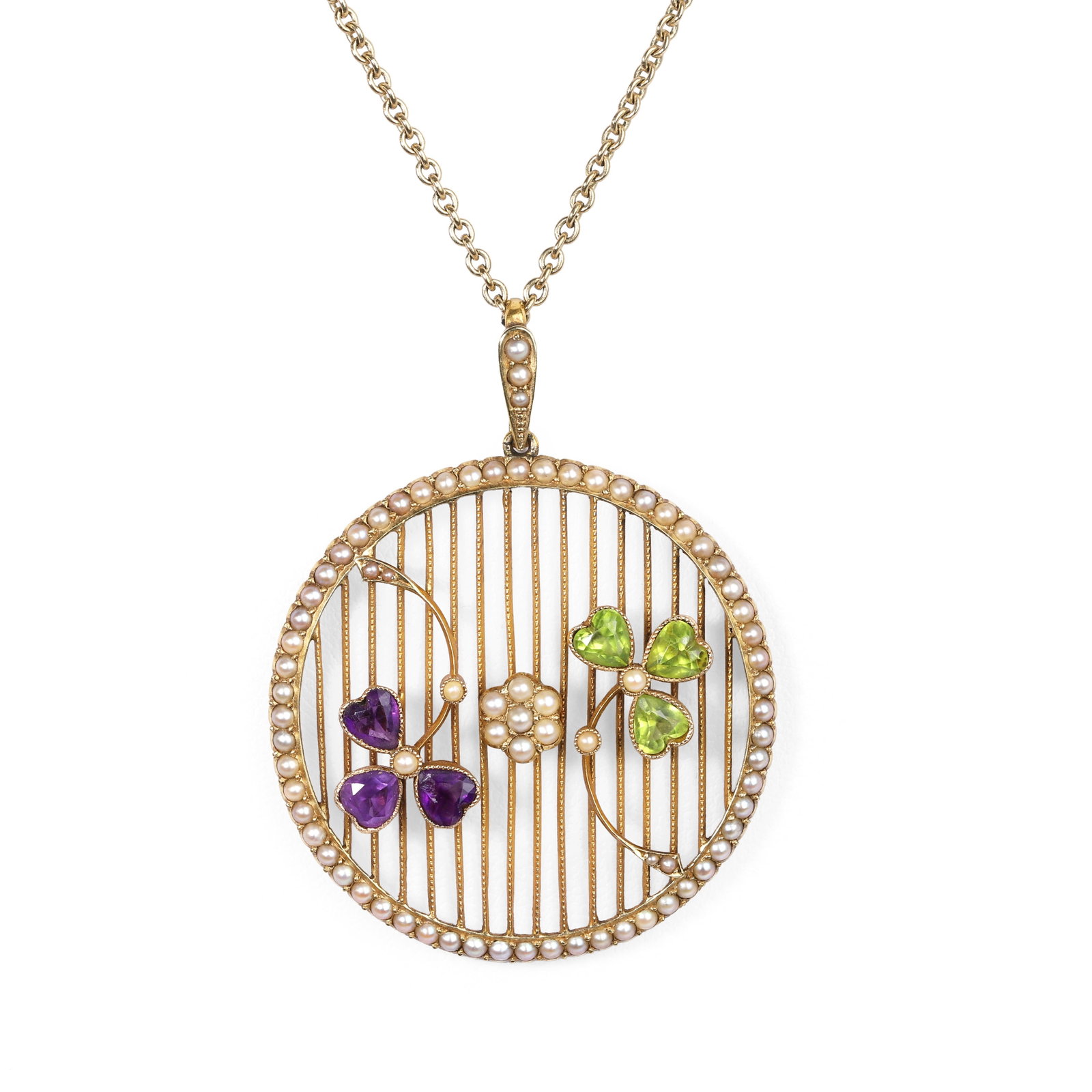 An Edwardian amethyst, peridot and split pearl pendant on chain,: An Edwardian amethyst, peridot and split pearl pendant on chain, composed of a circular lattice-work plaque with applied peridot and amethyst trefoils in a cross-over arrangement and centred by a spli