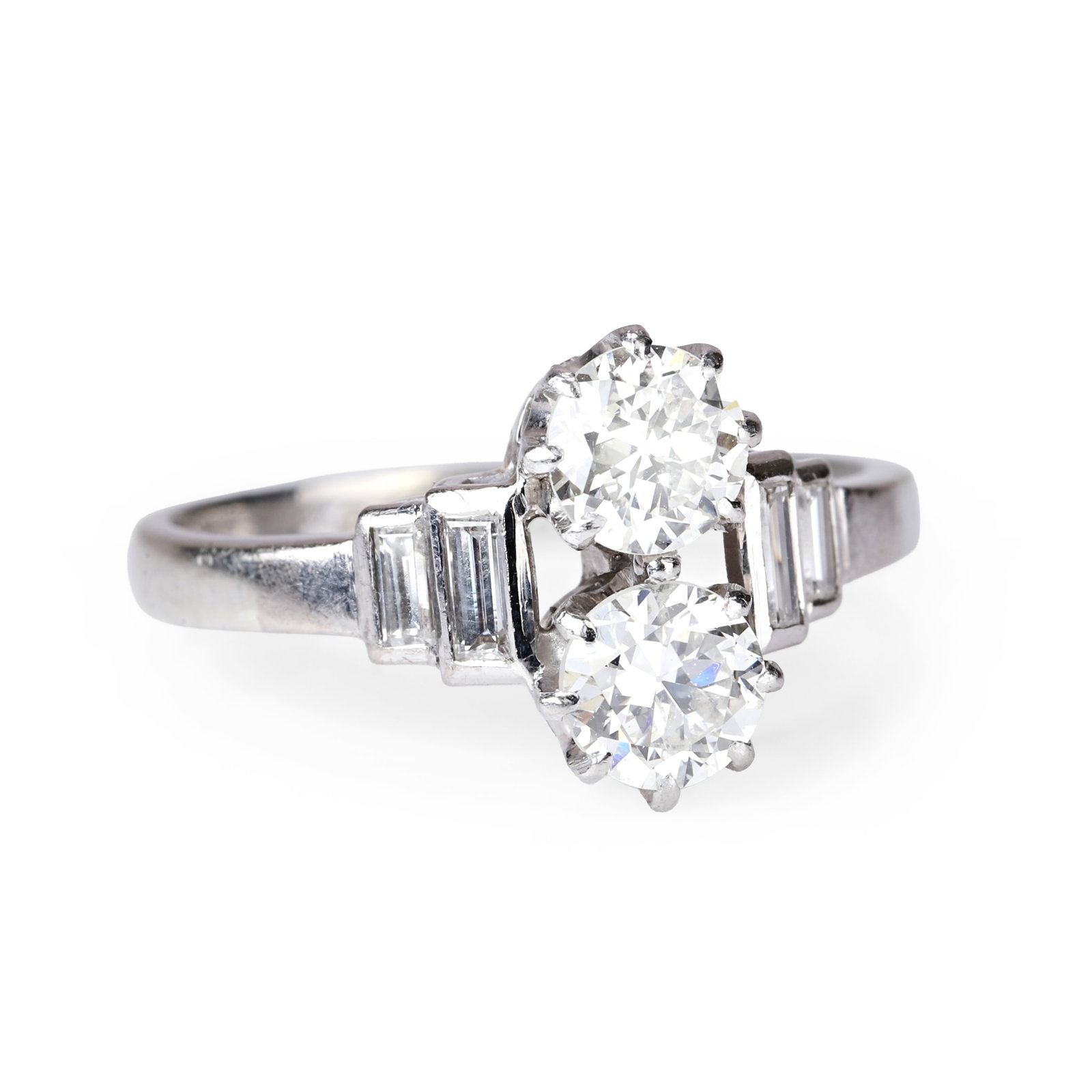 A diamond two stone ring,: A diamond two stone ring, comprising two transitional cut diamonds, vertically claw set between two graduated stepped baguette cut diamonds, rub over set on each shoulder, stamped 18ct & Plat, total a