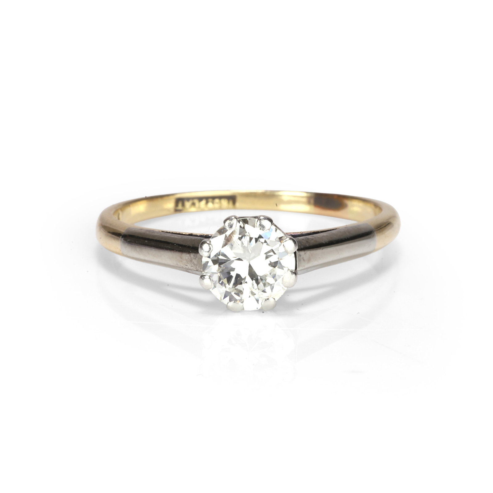 A diamond single stone ring,: A diamond single stone ring, the round cut diamond set with eight claws to a rex collet and gently tapering D profile band, stamped 18ct PLAT (Ring size O; 2.7g) Footnote: Buying this diamond ring at 