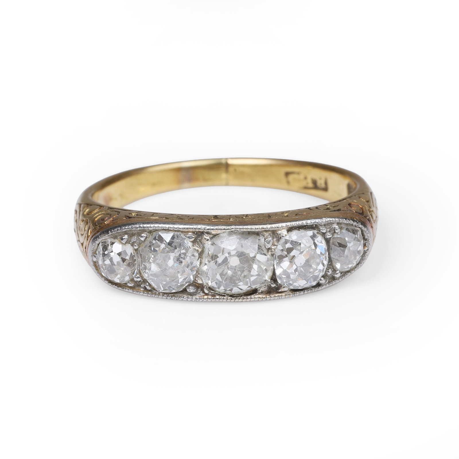 A diamond five stone carved half hoop ring,: A diamond five stone carved half hoop ring, set with five graduated old cut diamonds, to carved gallery sides and shoulders into a plain hoop. Stamped 22ct and tested as high carat gold (Ring size P;