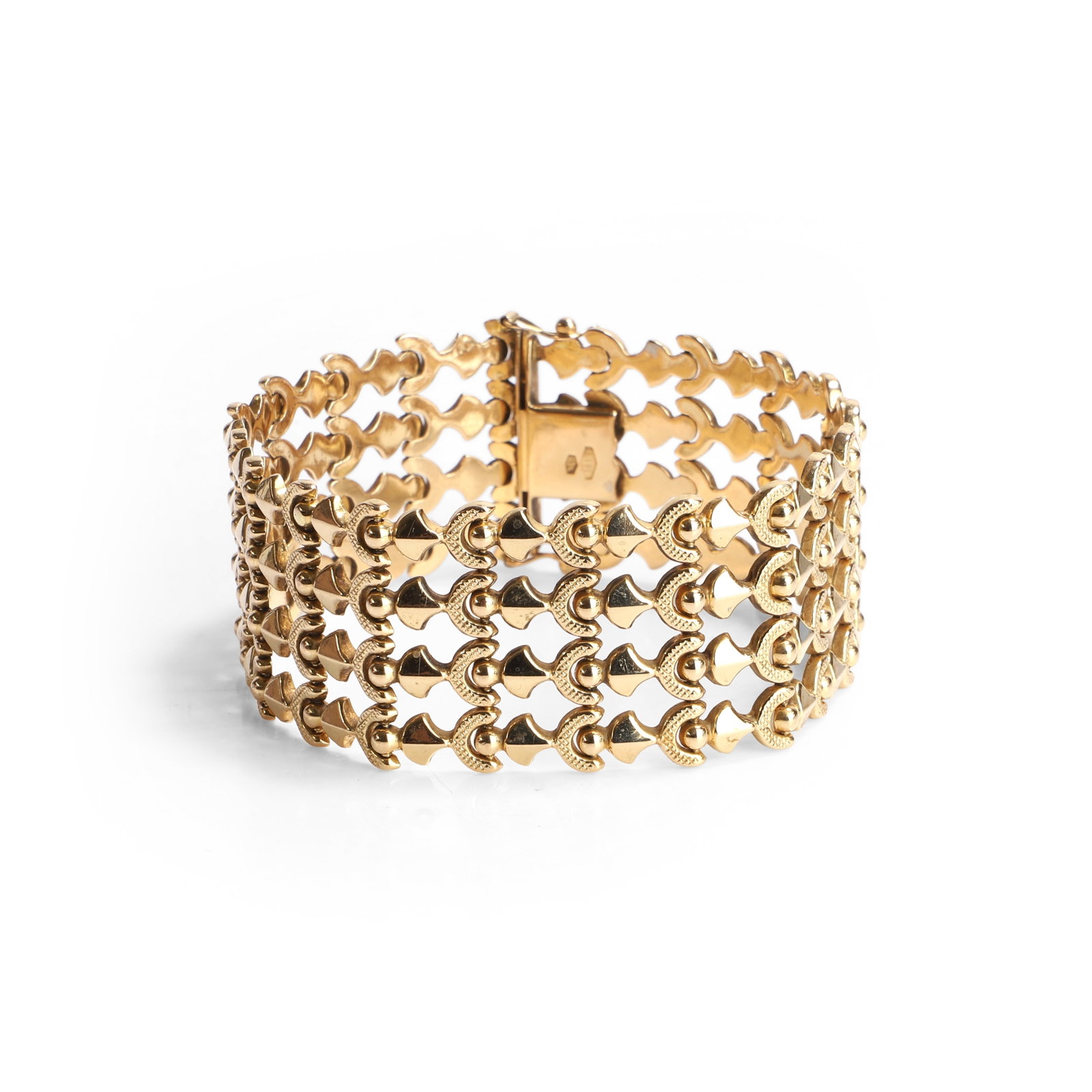 A mid-century Italian gold bracelet,: A mid-century Italian gold bracelet, of ornate design, with four rows of alternating polished and textured gold links, to a semi-concealed box clasp and twin figure of eight catches, tested as
