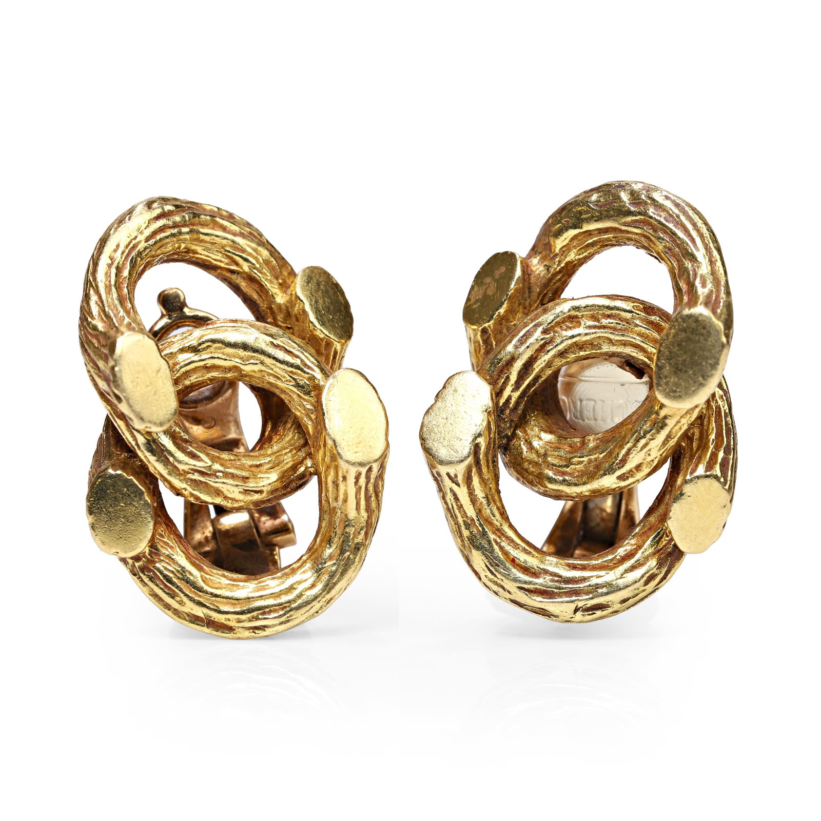 Boucheron, a pair of 18ct gold clip on earrings,: Boucheron, a pair of 18ct gold clip on earrings, of interlocking design with a bark texture finish, signed Boucheron, maker's mark, London 1978 (Length 2.2cm; 15.8g) Condition Report: Scratches and ma
