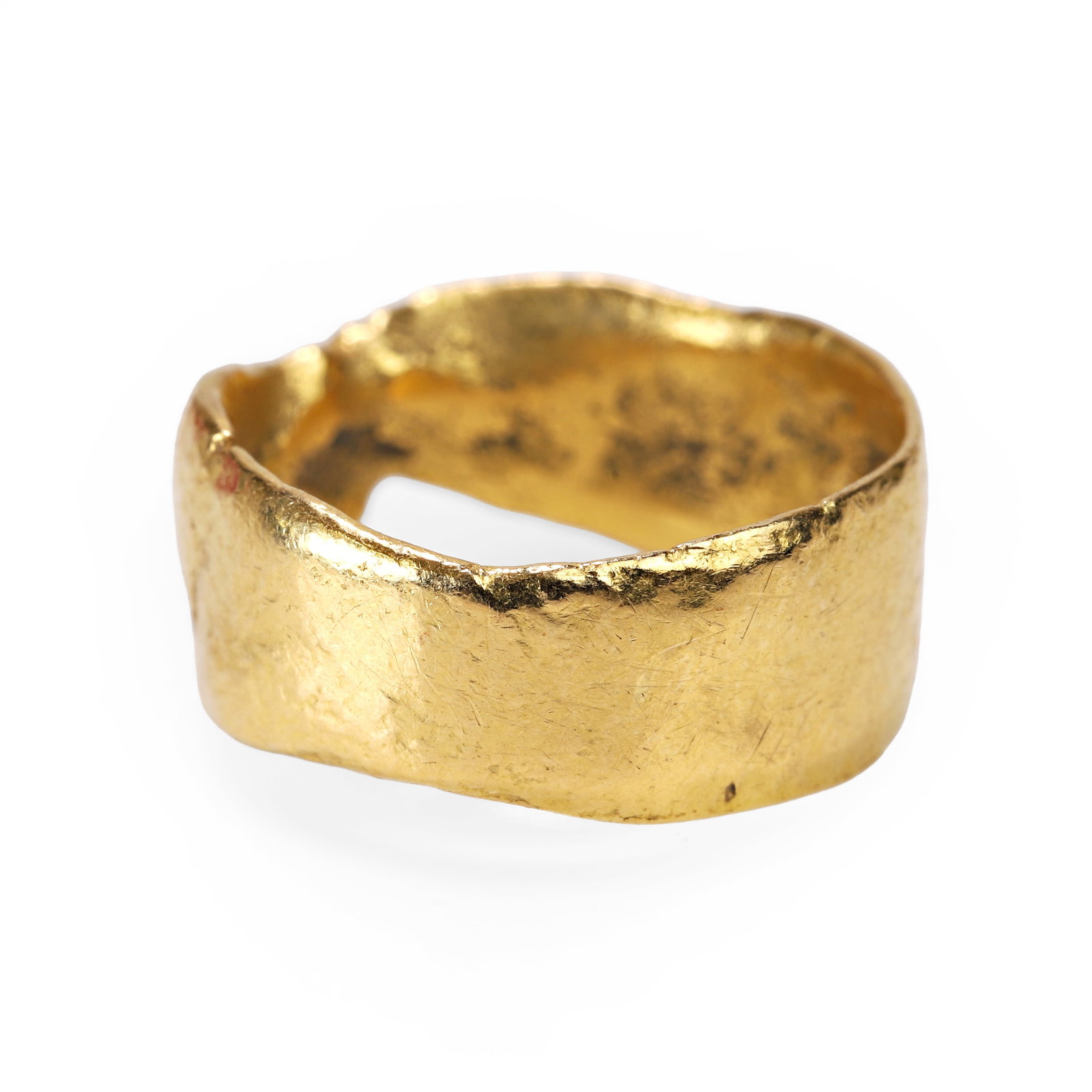 Polly Gasston, a 22ct gold band ring,: Polly Gasston, a 22ct gold band ring, of organic textured design, tapered to the top, hallmarked London 2010, maker's mark PG (Ring size H; 4.9g) Condition Report: Scratches and marks consistent with 