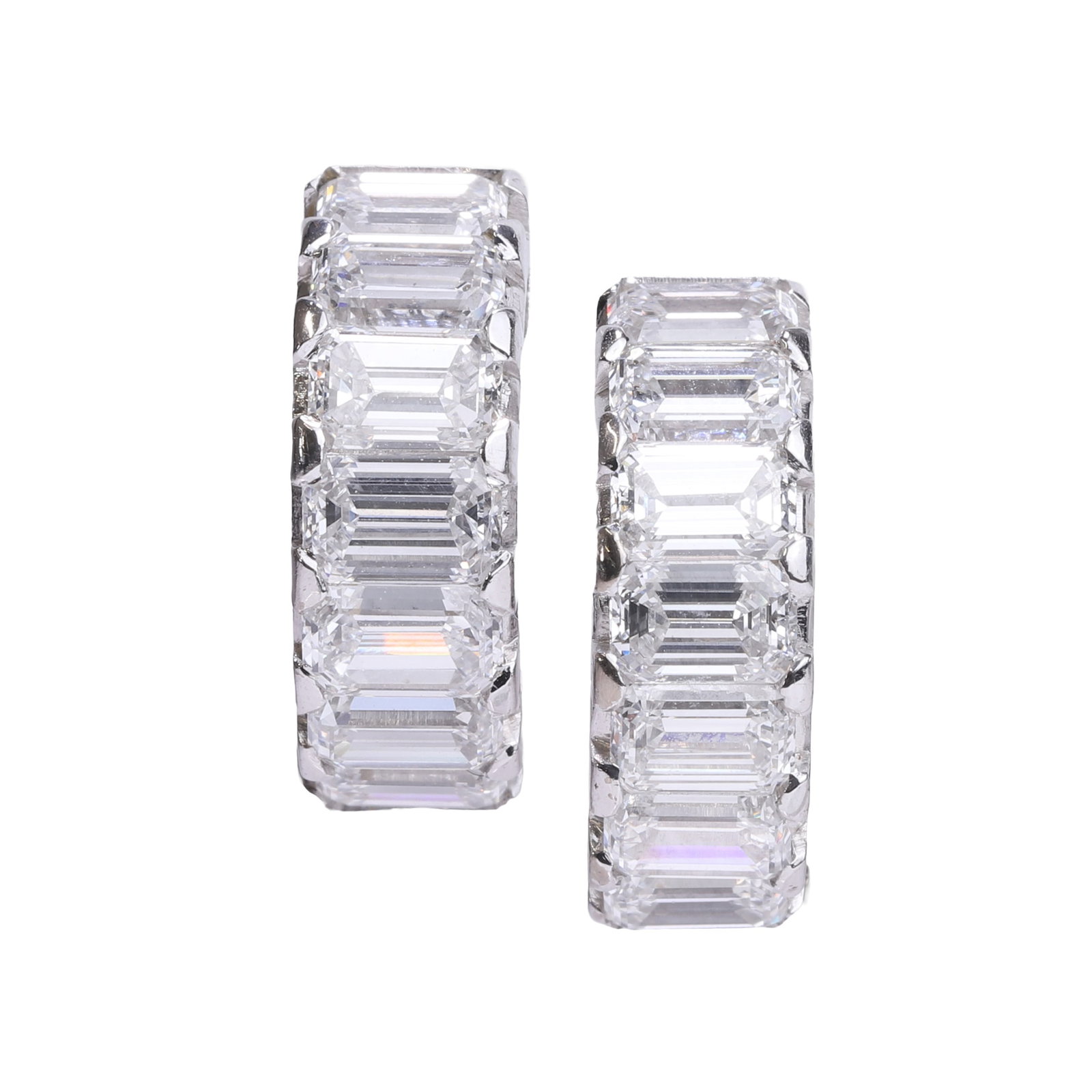 A pair of diamond cuff earrings,: A pair of diamond cuff earrings, composed of fourteen emerald cut diamonds, with hinged pin fitting, unmarked and tested as approximately 18ct white gold (Outer diameter 1.5cm; 5.8g) Condition Report: