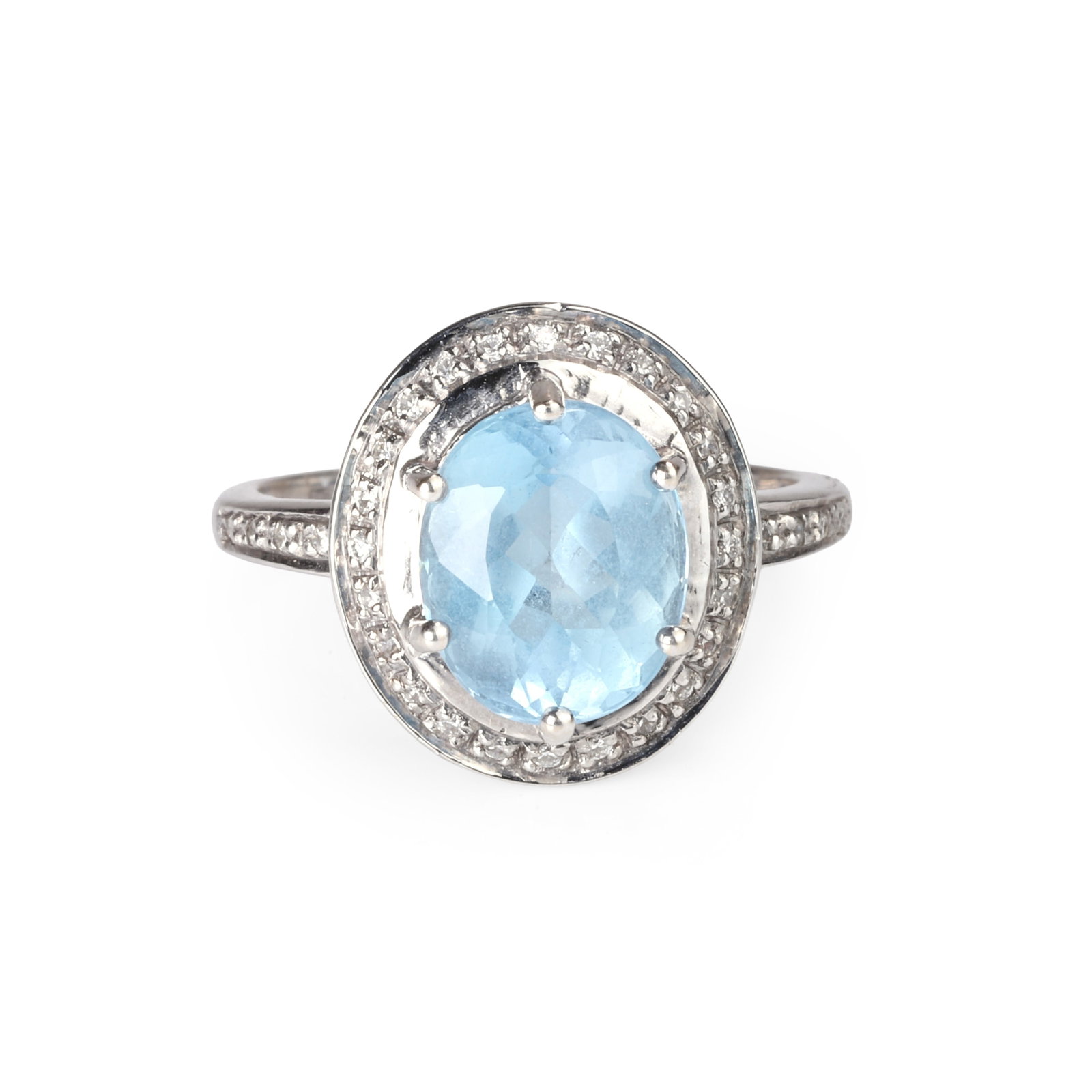 An 18ct white gold aquamarine and diamond ring,: An 18ct white gold aquamarine and diamond ring, the oval mixed cut aquamarine claw set within a diamond halo surround, to a tapered band with diamond-accented shoulders. Hallmarked Birmingham, stamped