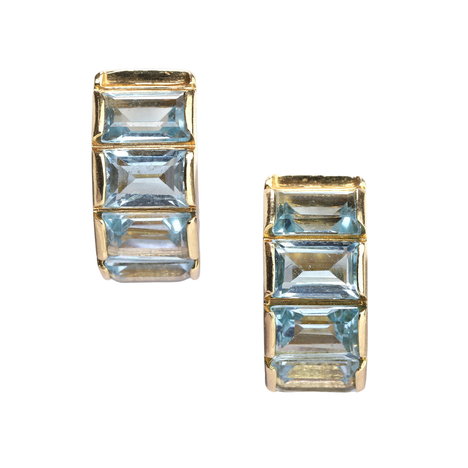 A pair of 18ct gold blue topaz 'huggie' earrings,: A pair of 18ct gold blue topaz 'huggie' earrings, each hoop set with six emerald cut blue topaz, signed Le Gi, hallmarked London 750 (Diameter 1.5cm; width 7mm; 10.4g) Condition Report: Light surface 