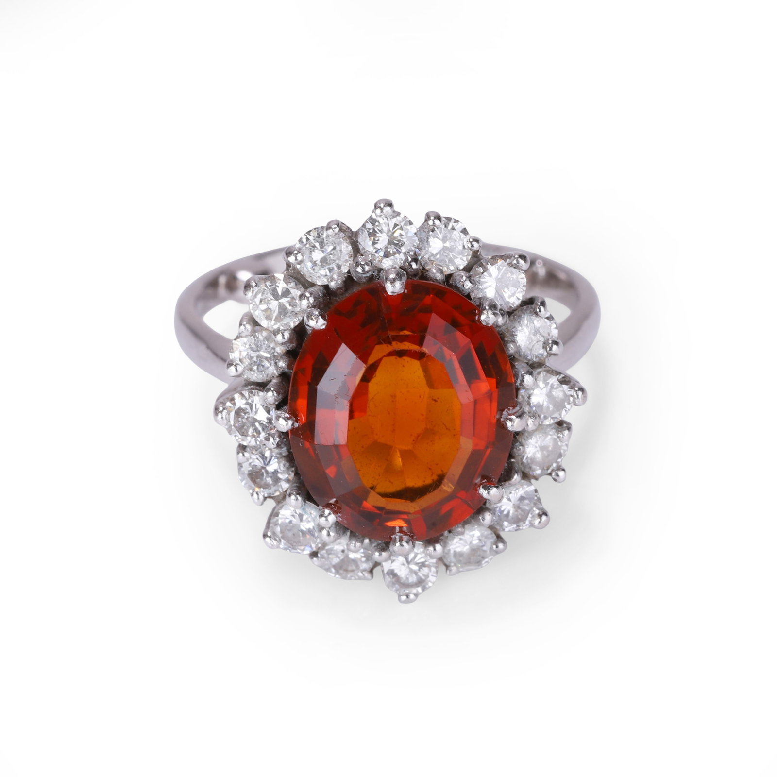 A citrine and diamond cluster ring,: A citrine and diamond cluster ring, the central oval citrine claw set and surrounded by sixteen round brilliant cut diamonds to a wire basket mount and tapered band with sizing beads, unmarked and tes