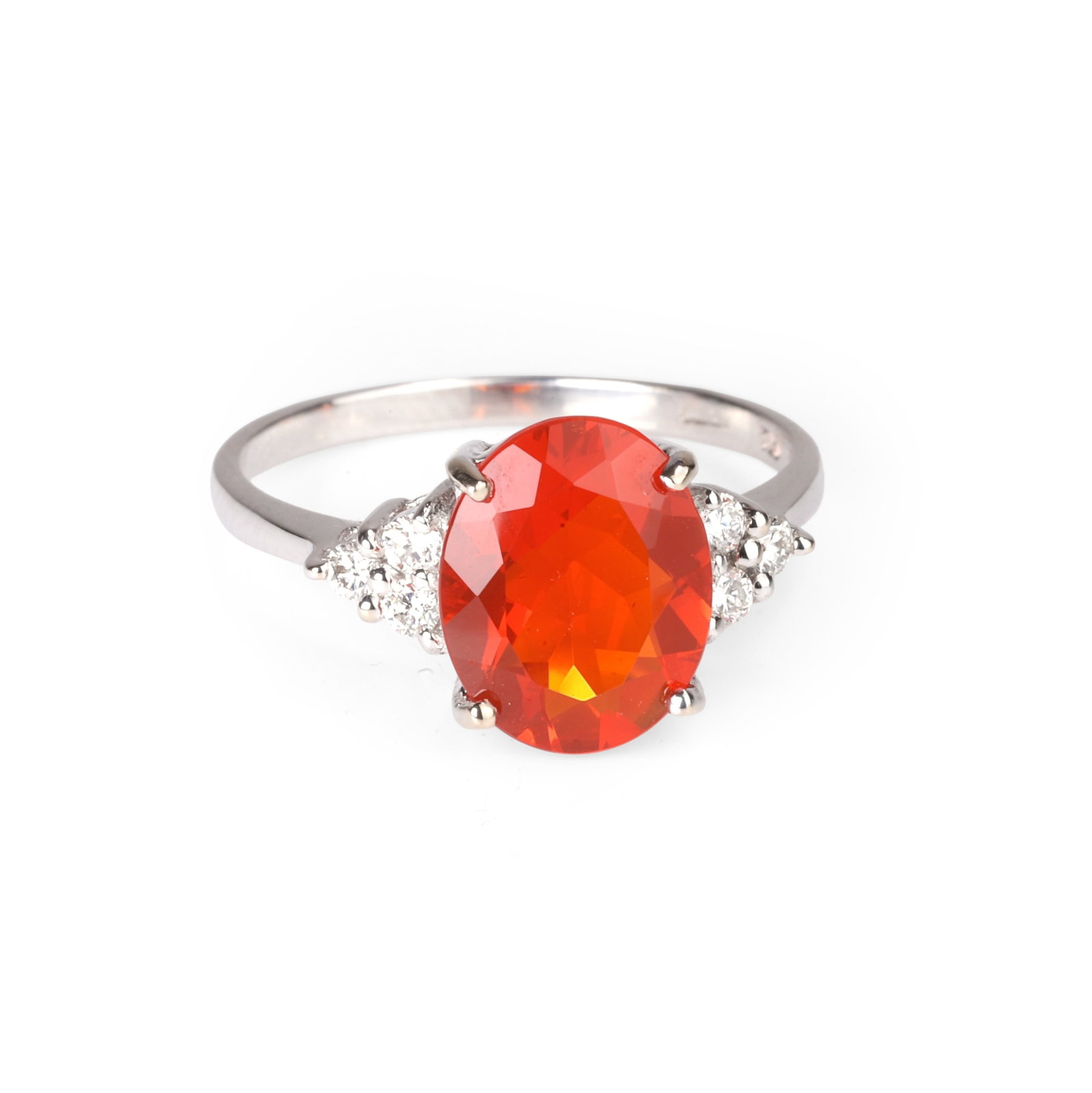 An 18ct white gold fire opal and diamond ring,: An 18ct white gold fire opal and diamond ring, the oval fire opal claw set to a galleried mount and flanked by a trefoil of round brilliant cut diamonds to a gently tapered band. Hallmarked Birmingham