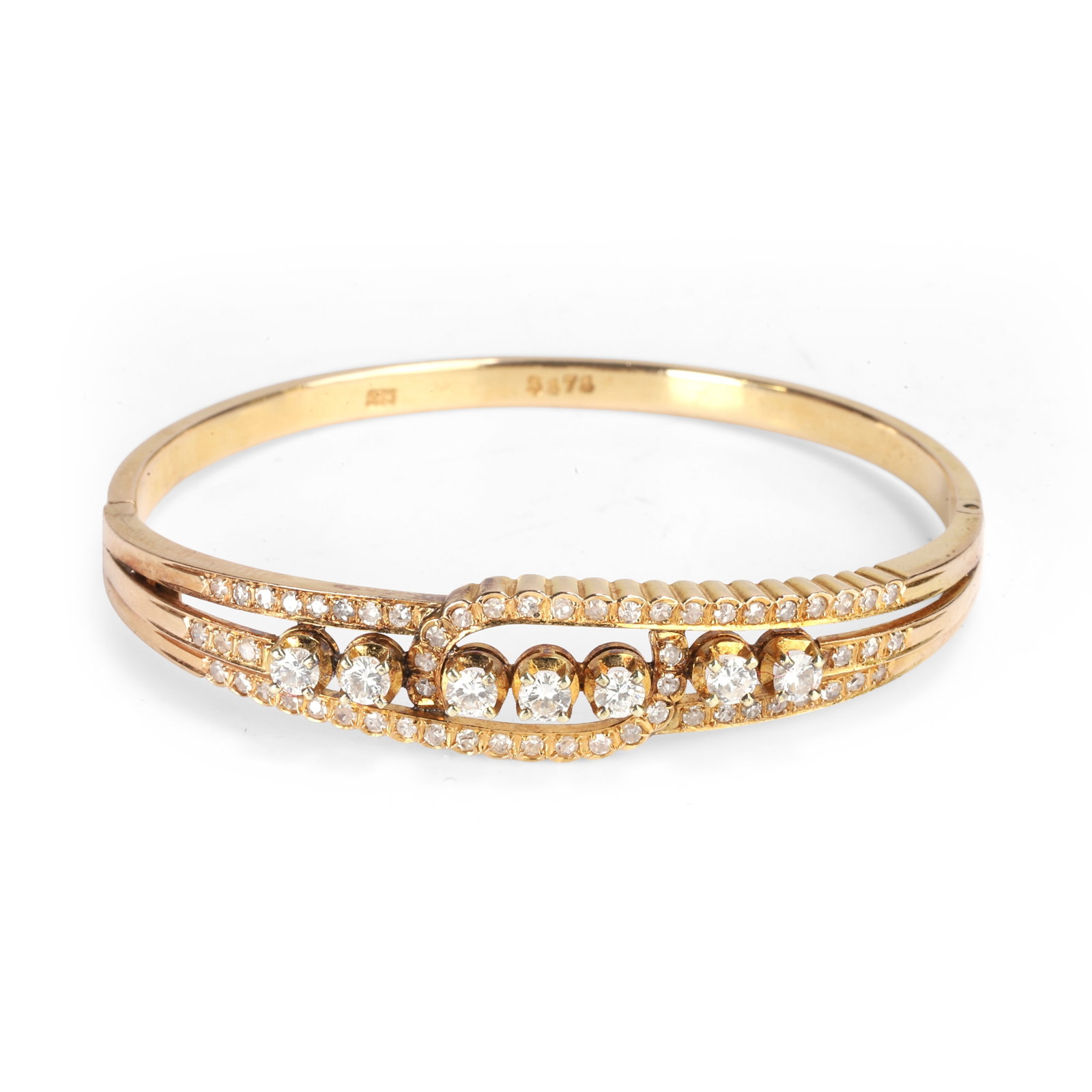 A diamond crossover design bangle,: A diamond crossover design bangle, of three cross over bars, the central bar claw set with six round brilliant cut diamonds, with three eight cut diamonds grain set to each shoulder, the outer bars sc