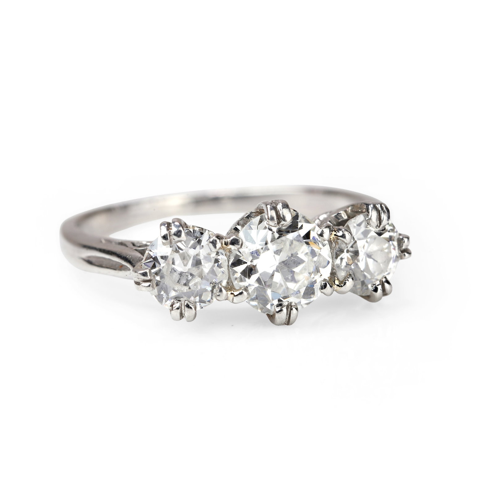 A diamond three stone ring,: A diamond three stone ring, composed of three graduated transitional cut diamonds set with split claws to scroll detail collets and tapered band. Unmarked and testing as platinum, total diamond weight