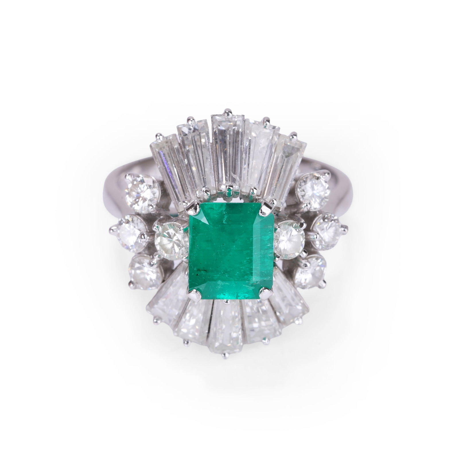 An emerald and diamond ring,: An emerald and diamond ring, the central emerald cut emerald claw set with a fan of baguette cut diamonds above and below and flanked by four round brilliant cut diamonds either side to a tapered 'D' 