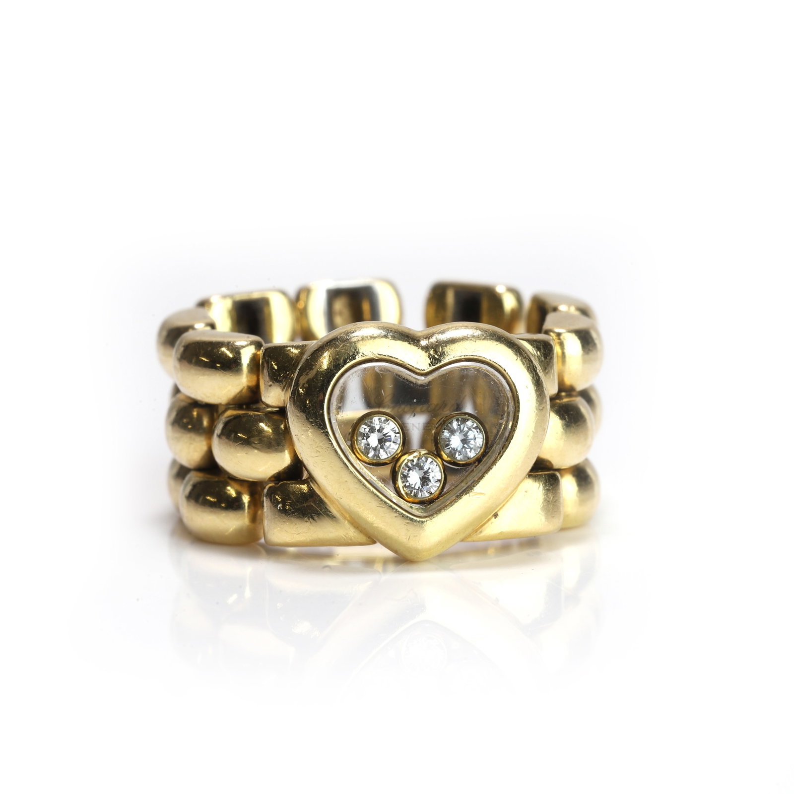 Chopard, an 18ct gold Happy Diamond chain ring,: Chopard, an 18ct gold Happy Diamond chain ring, centred with a heart-shaped glazed panel enclosing three floating round brilliant diamonds, to a brick link chain hoop, signed Chopard, 750, Swiss assay