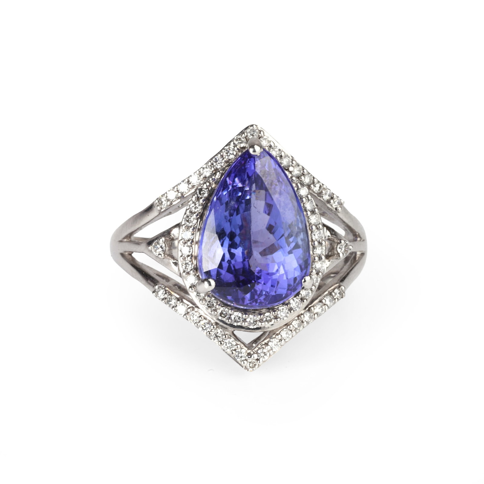 An 18ct white gold tanzanite and diamond ring,: An 18ct white gold tanzanite and diamond ring, composed of a pear shaped tanzanite, claw set and surrounded by a halo of round brilliant cut diamonds with a diamond set chevron at top and bottom, lead