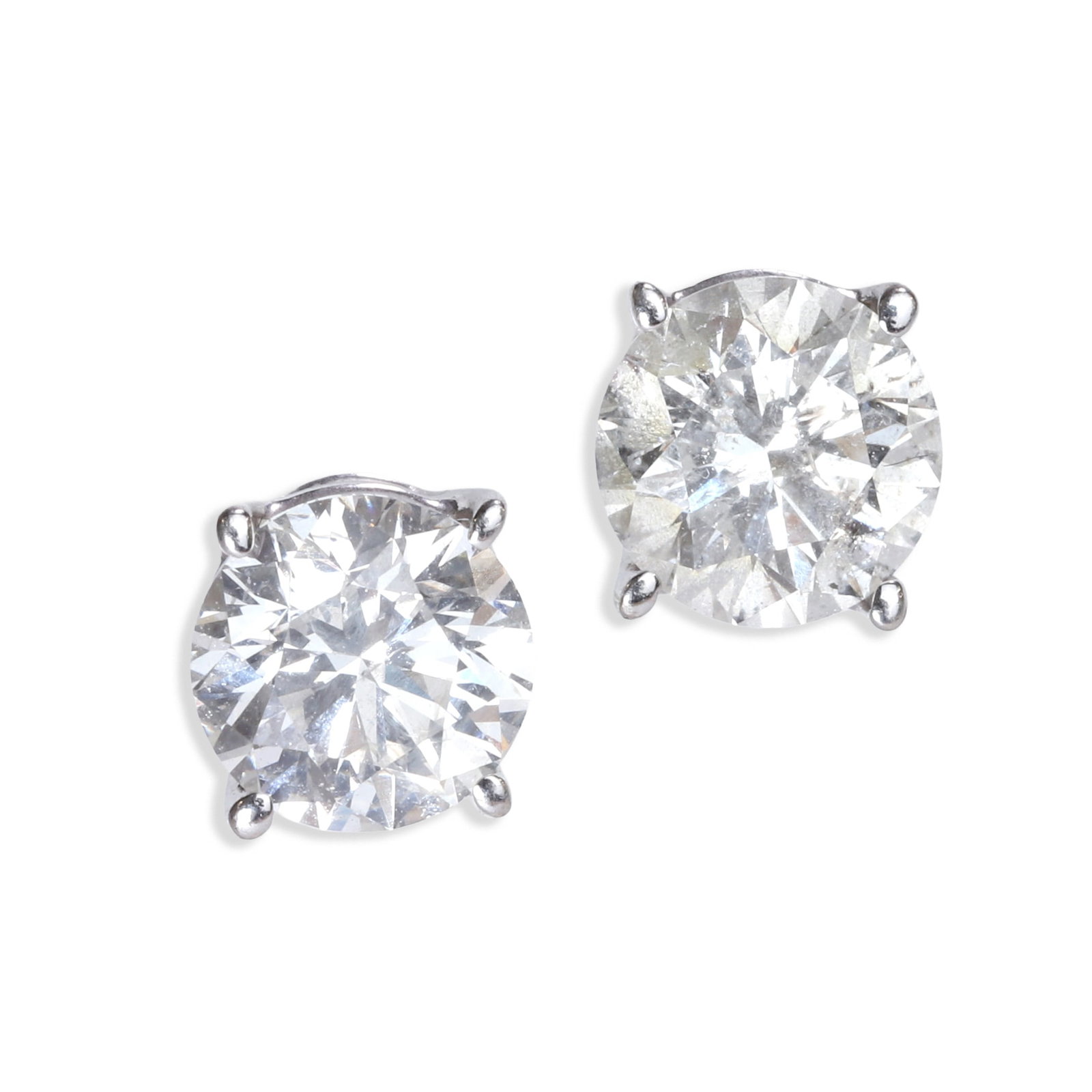 A pair of diamond stud earrings,: A pair of diamond stud earrings, each four claw set with a round brilliant cut diamond, mounted in white gold, stamped 14k, to post and butterfly fittings (Diameter 5.6mm; 1.1g) Footnote: Accompanied 