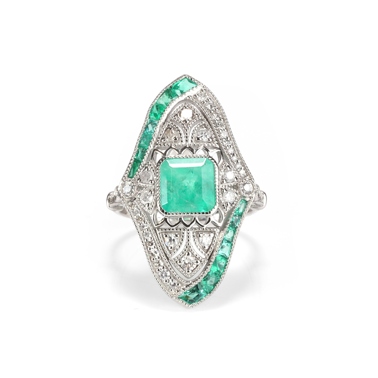 An emerald and diamond panel ring,: An emerald and diamond panel ring, centrally featuring an emerald cut diamond within a surround of single cut diamonds in millegrain setting, to a pierced lozenge shape panel with calibre cut emerald 