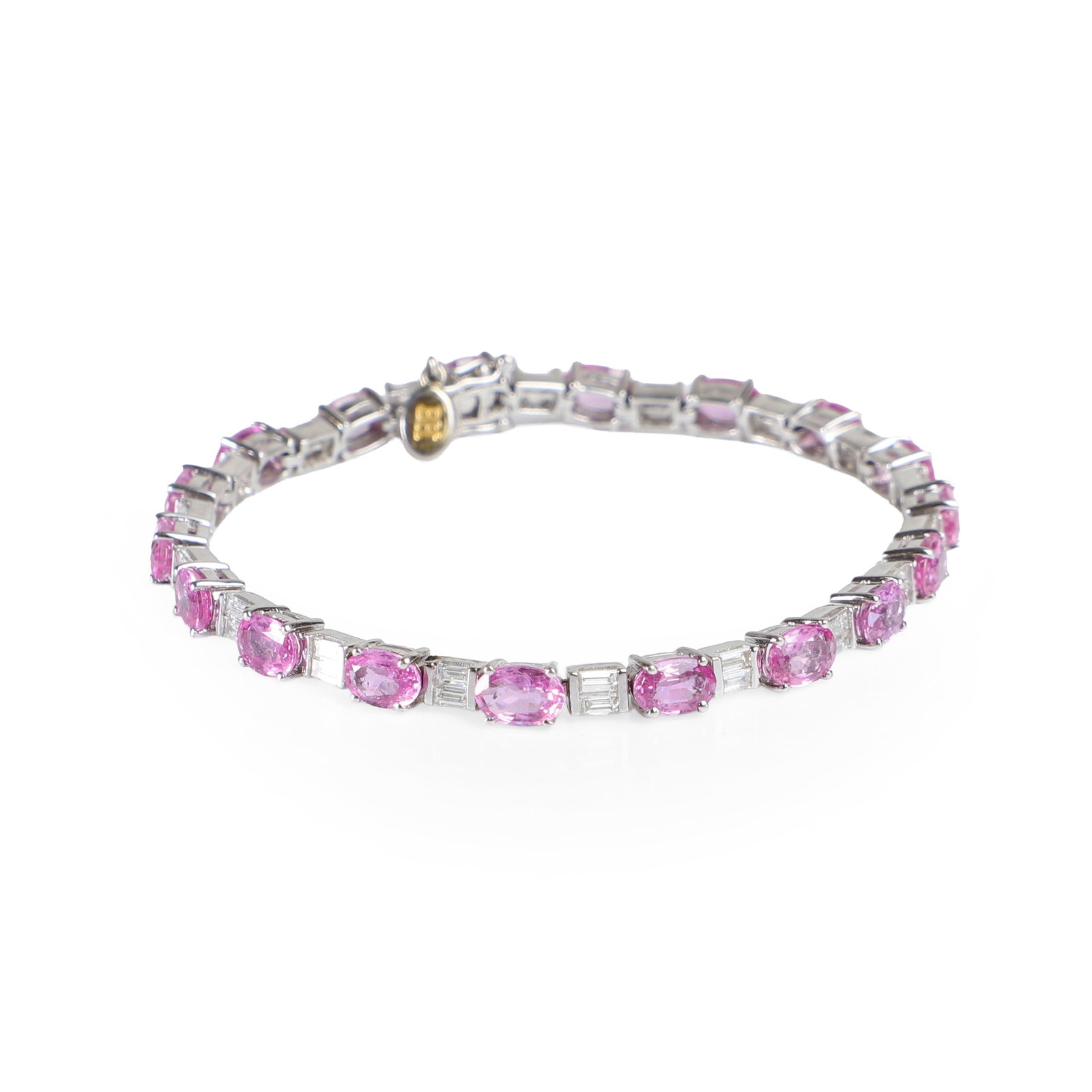 An 18ct white gold pink sapphire and diamond line bracelet,: An 18ct white gold pink sapphire and diamond line bracelet, comprising eighteen oval claw set pink sapphires, interspaced with pairs of bar set baguette diamonds to an integrated clasp with two figure