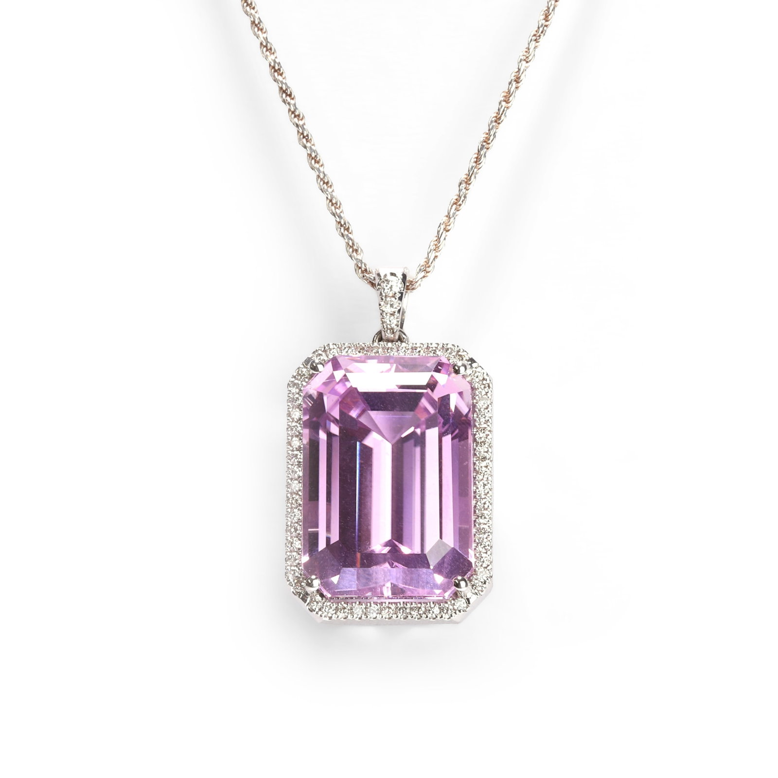 A white gold kunzite and diamond pendant,: A white gold kunzite and diamond pendant, the rectangular step cut kunzite, weighing approximately 45.94ct, within a surround of round brilliant cut diamonds and tapered diamond set bale, mounted in w