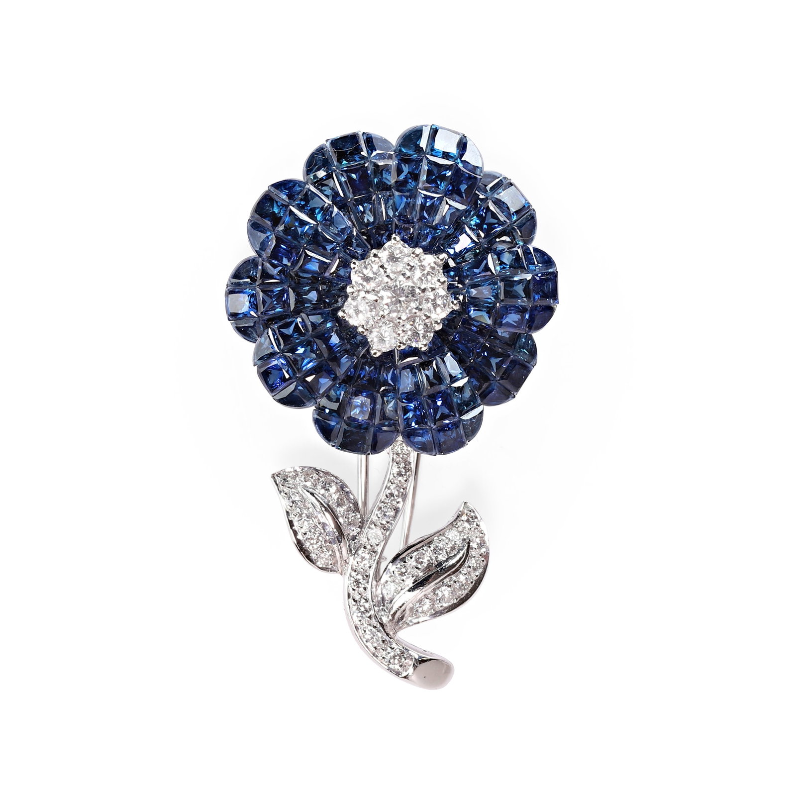 A sapphire and diamond floral brooch,: A sapphire and diamond floral brooch, designed as a flower, with a central cluster of round brilliant cut diamonds within petals of invisibly set calibre cut sapphires, to round brilliant cut diamond 