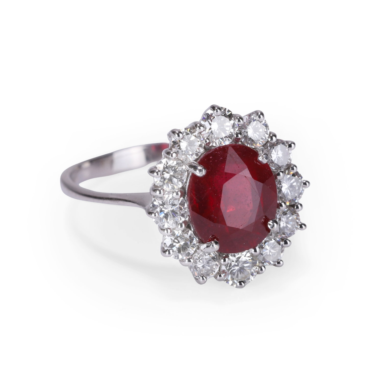 A ruby and diamond cluster ring,: A ruby and diamond cluster ring, the oval mixed cut ruby, weighing approximately 3.70ct, within a surround of round brilliant cut diamonds, all claw set to a wire basket setting. Mounted in white gold