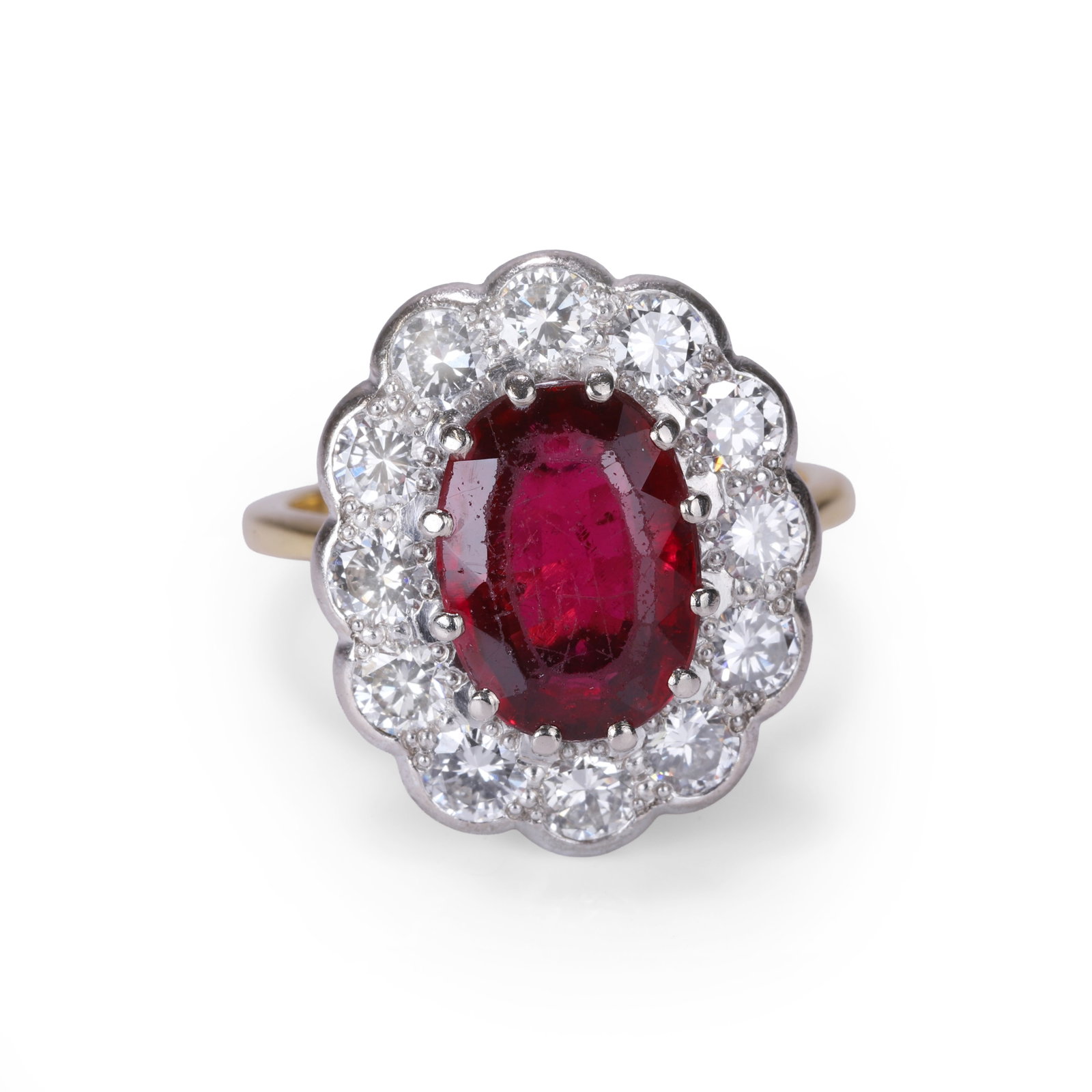 A rubellite tourmaline and diamond cluster ring,: A rubellite tourmaline and diamond cluster ring, the oval cut rubellite tourmaline claw set within a surround of round brilliant cut diamonds, mounted in white upon a yellow gold gallery, stamped