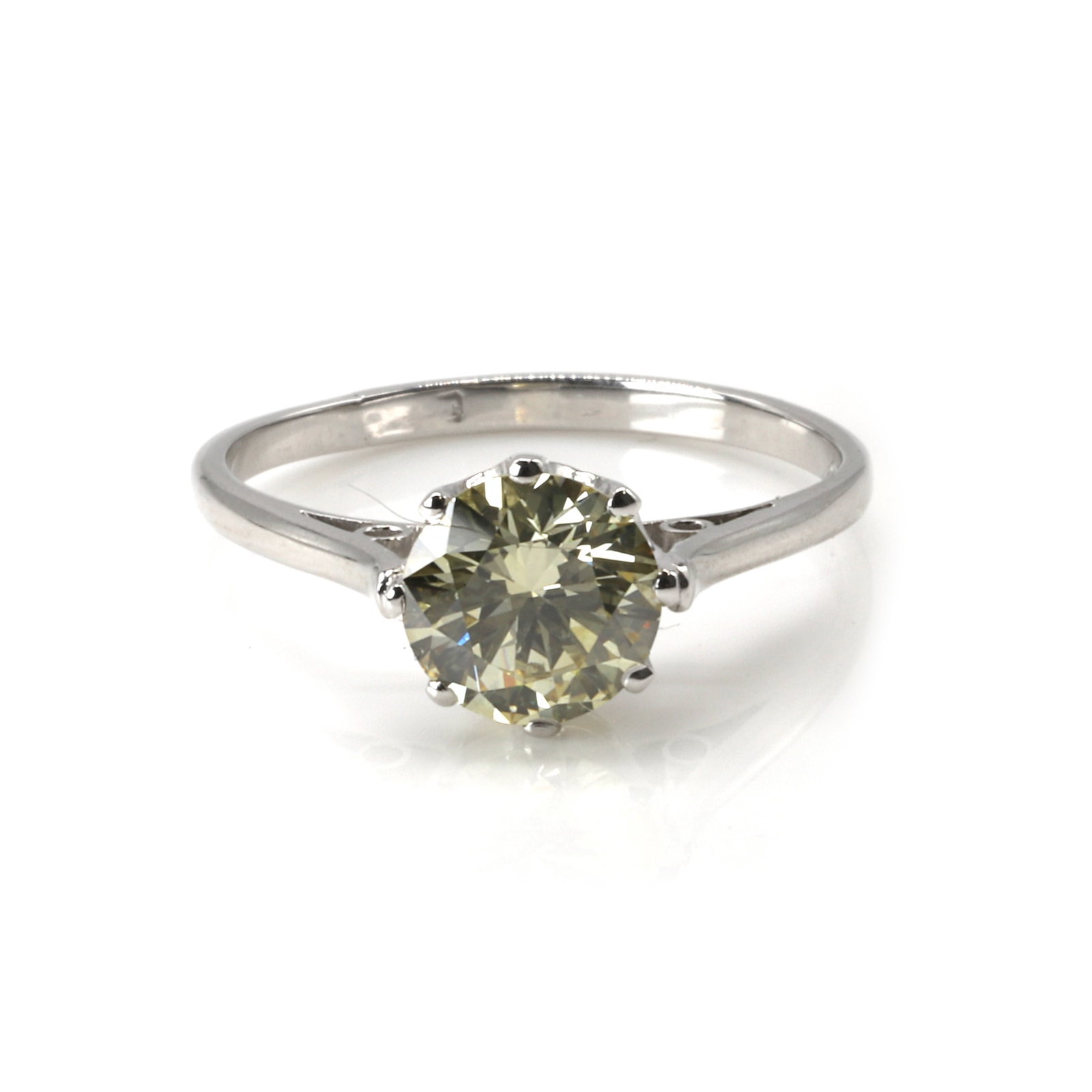 † A fancy yellow diamond single stone ring,: † A fancy yellow diamond single stone ring, the round brilliant cut fancy yellow diamond, weighing 1.51ct, claw set between chenier shoulders leading to a plain band (Ring size O¼; 3.3