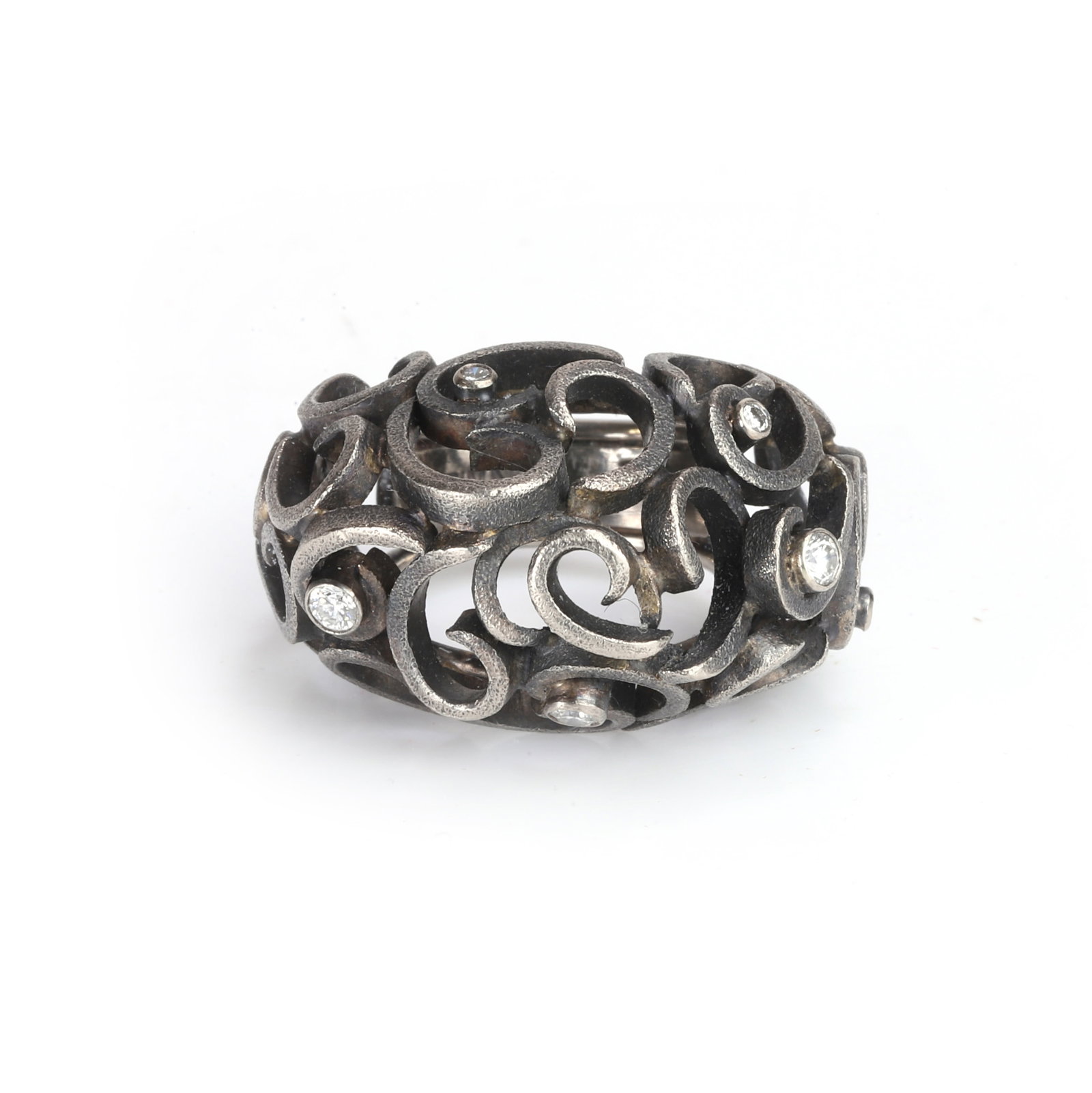 Grima, a diamond bombé ring,: Grima, a diamond bombé ring, of pierced scrollwork design, highlighted with graduated round brilliant cut diamonds, to a black rhodium-plated textured mount. Signed Grima, 750, with maker's case 