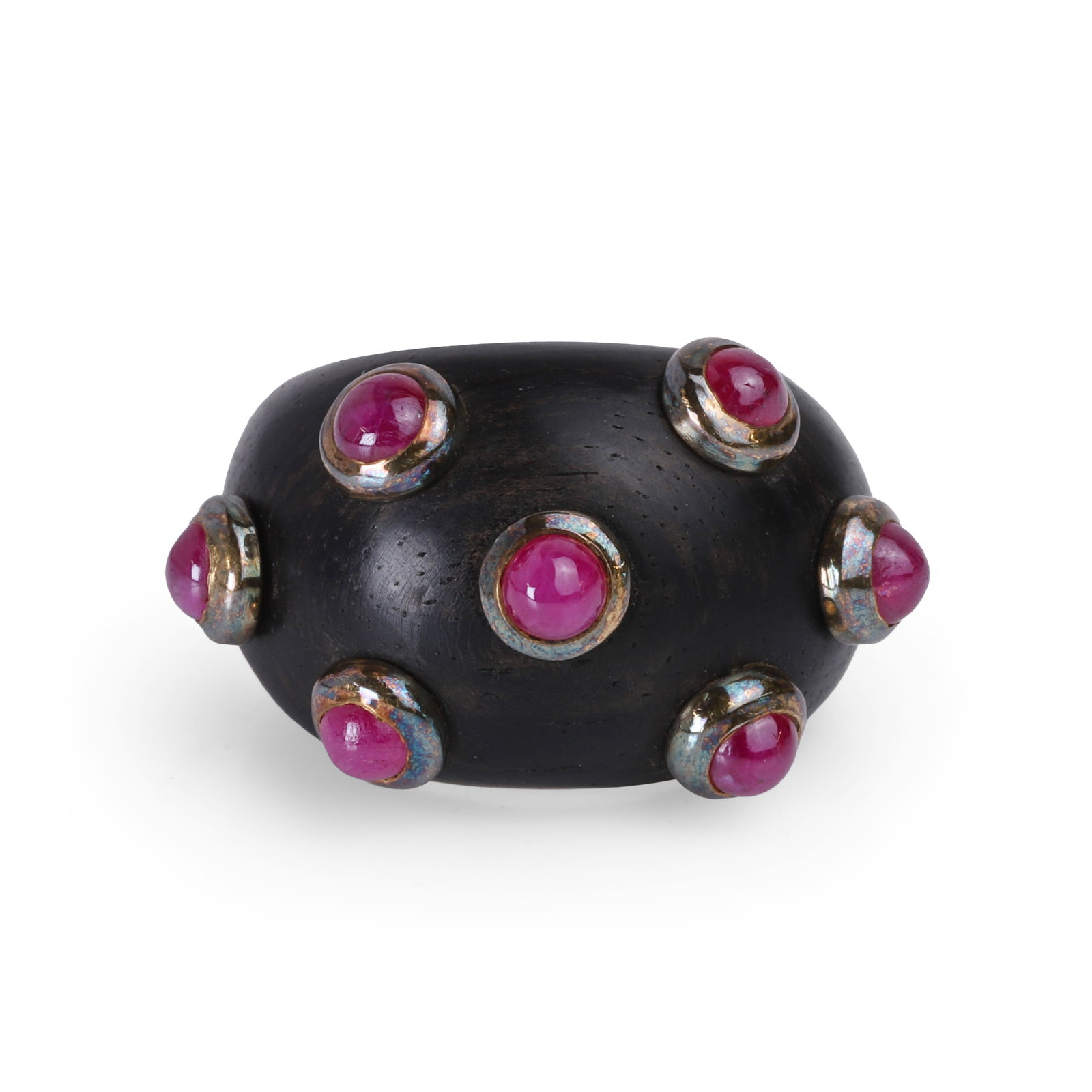 L'Oree du Bois, an ebony and ruby bombe ring,: L'Oree du Bois, an ebony and ruby bombe ring, the ebony panel studded with seven round cabochon rubies in gold 'doughnut' settings, unmarked, signed L'Oree du Bois, tested as approximately 18ct gold (