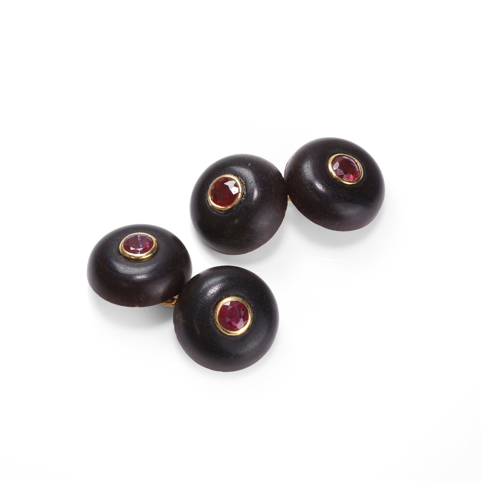 Poiray, a pair of gold mounted ebony and gemstone set cufflinks,: Poiray, a pair of gold mounted ebony and gemstone set cufflinks, each dome-shaped ebony panel studded with a collet set round cut ruby, joined by chain link connections, mounted in 18ct gold, signed P