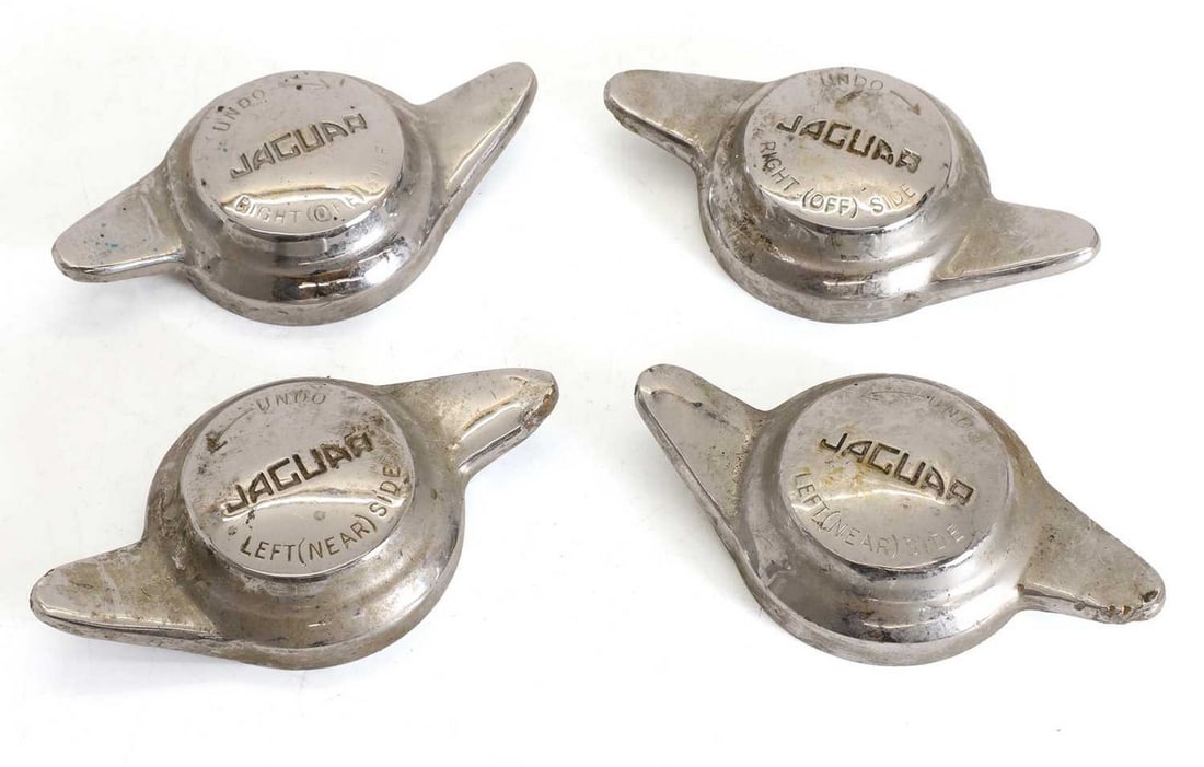 A set of four matching Jaguar knock-off spinners, circa 1960s,: A set of four matching Jaguar knock-off spinners, circa 1960s, all chrome-plated, with Jaguar embossing, and threaded to the verso, two right-hand sides and two left-hand sides (18.5cm wide) (4)