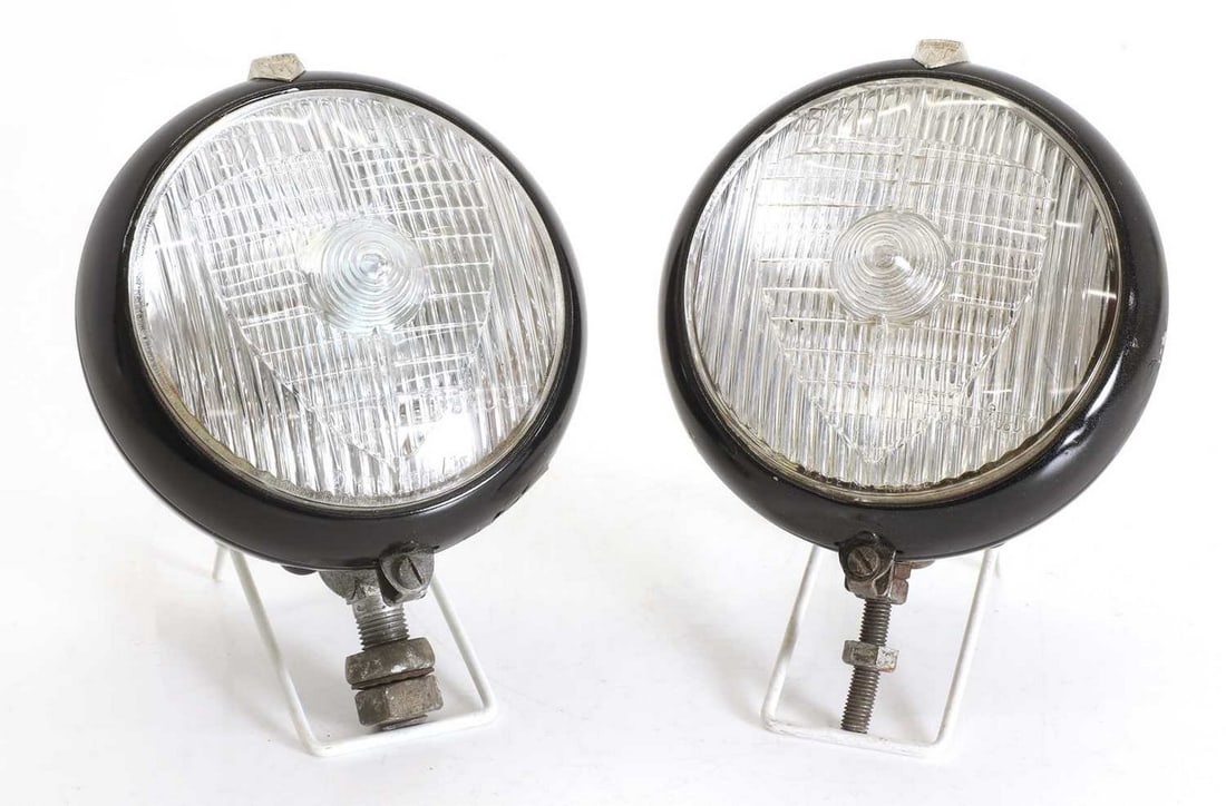 A matching pair of Marchal 670 spotlights, circa 1960s,: A matching pair of Marchal 670 spotlights, circa 1960s, each finished in black paint, with matching embossed case, fluted shield glass, both in blue fabric cover (lens diameter 4.5 inches) (2)