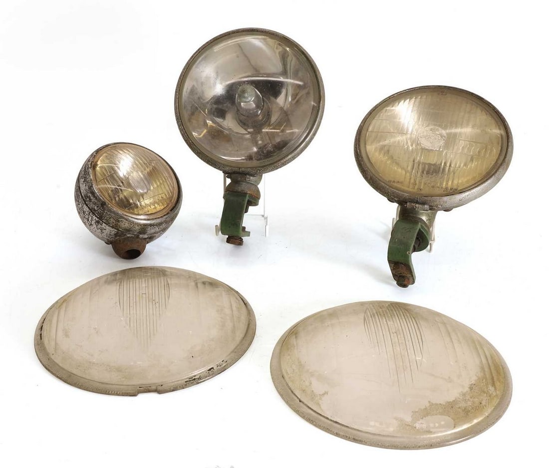 A group of Lucas lamps, 1930s and later,: A group of Lucas lamps, 1930s and later, comprising a large pair of 'cat's eye' lenses, two non-matching 7-inch lights, as well as one smaller fog lamp (largest 9.5-inch diameter) (5)