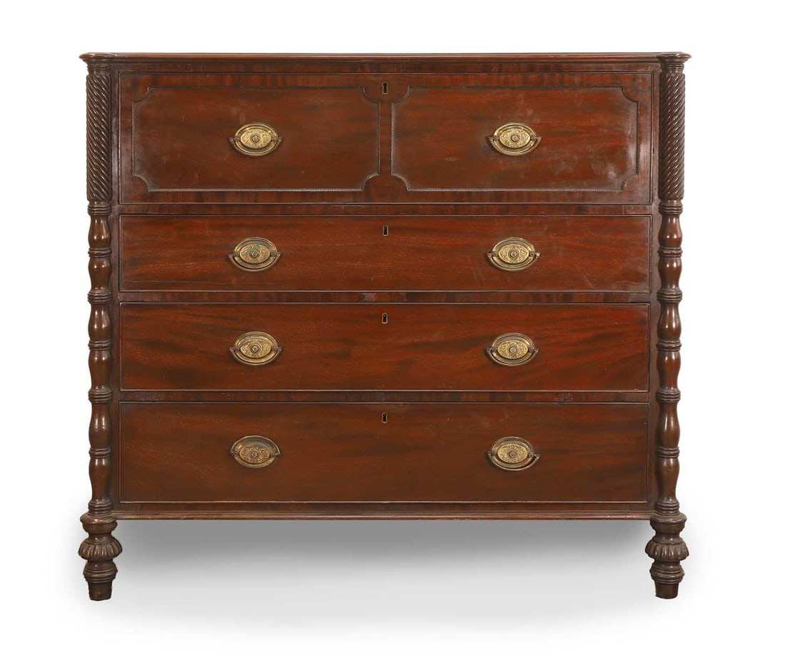A mahogany secretaire chest of drawers, early 19th century,: A mahogany secretaire chest of drawers, early 19th century, with rope twist and turned columns either side, with secretaire compartment to the top, the interior with green felt writing pad and banded
