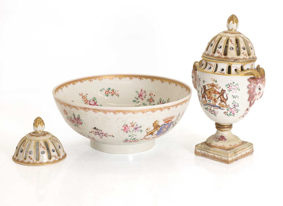 A Sampson armorial bowl 19th century,: A Sampson armorial bowl 19th century, with a central crest amongst floral sprays, together with a similar lidded vase and lid, decorated with a similar amorial style and with ram's head mask handles