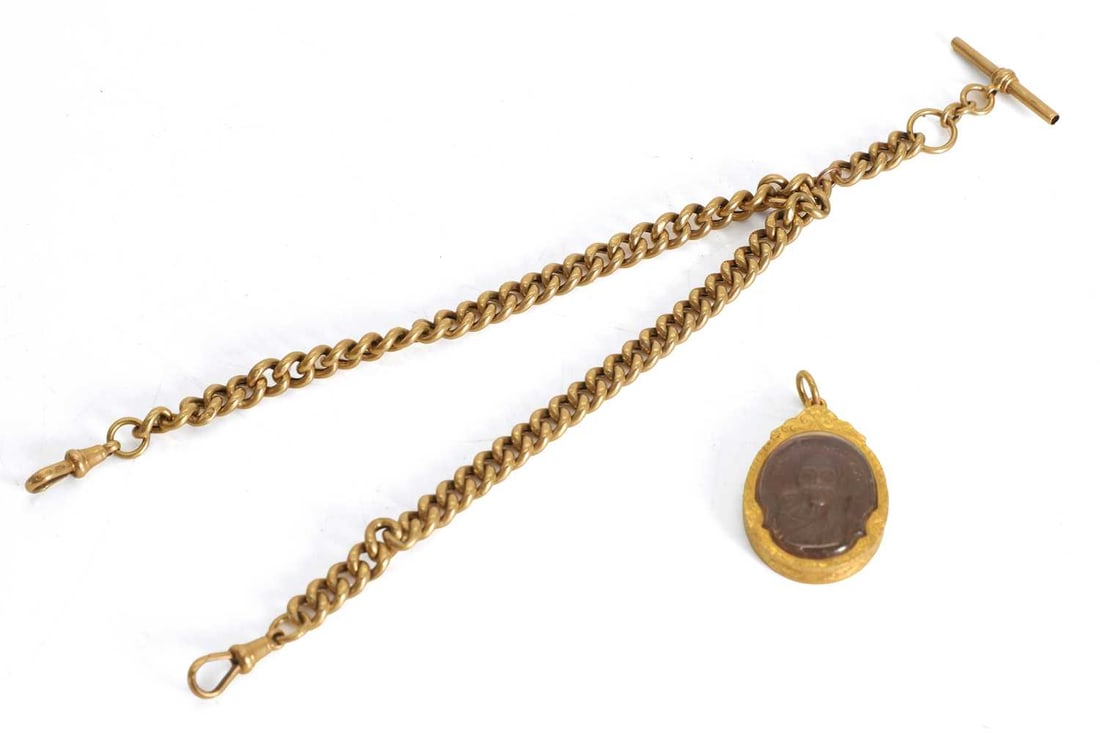 An 18ct gold Albert chain,: An 18ct gold Albert chain, stamped 18ct on T bar, links individually stamped 18ct, tested as approximately 18ct gold, the pendant enclosing a Thai amulet depicting a Theravada monk Chain, 36cm long
