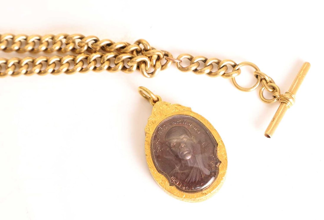 An 18ct gold Albert chain, - 2