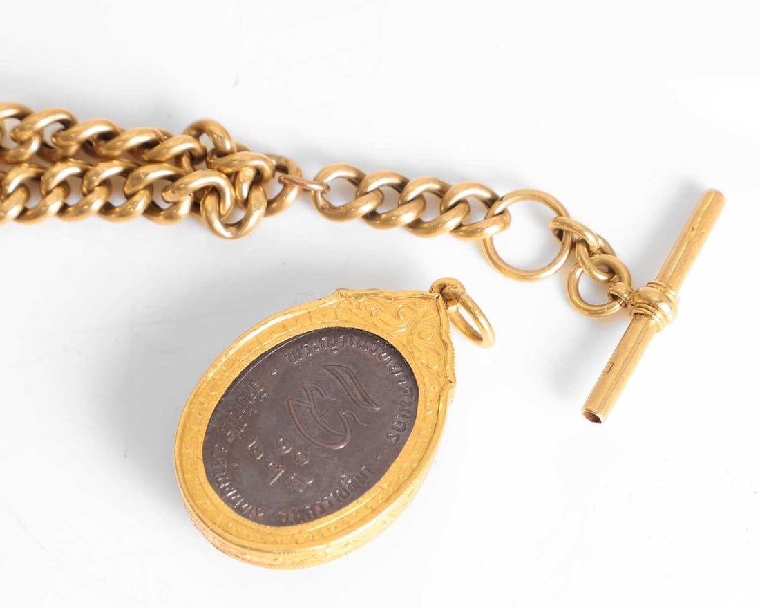 An 18ct gold Albert chain, - 3