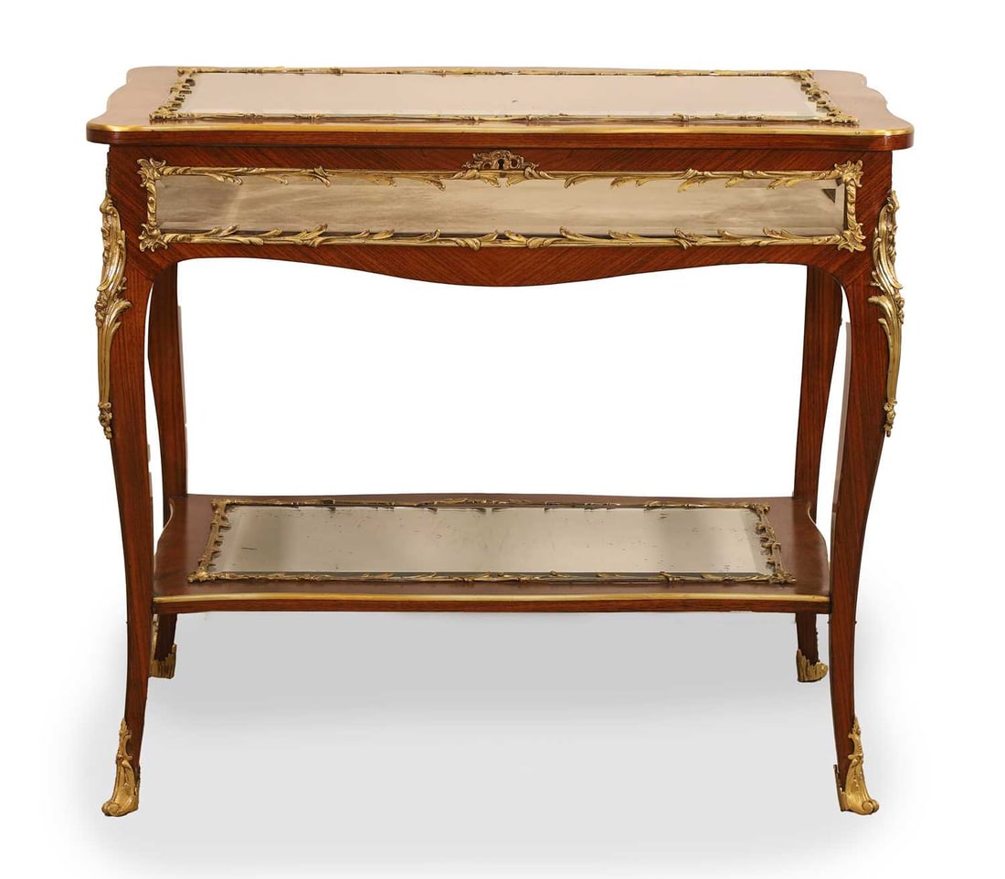 A Kingwood and gilt mounted vitrine, late 19th century,: A Kingwood and gilt mounted vitrine, late 19th century, the glass panels bevelled, the hinged top opening to reveal the interior fitted plush panel, with a bevelled mirror undertier 90.5cm wide,