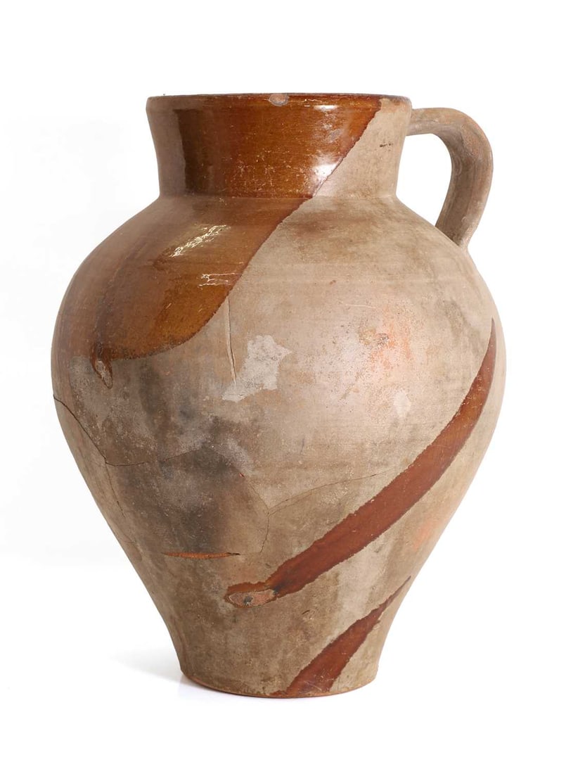 A French terracotta semi glazed jug, 18th / 19th century,: A French terracotta semi glazed jug, 18th / 19th century, with single handle, of tapering form, with glazed interior spilling to exterior, 38.5cm high, 30cm wide Condition Report: chips to the rim,