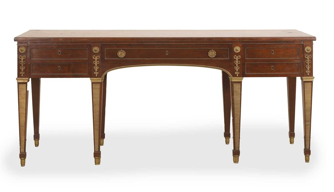 A mahogany and gilt mounted desk, 20th century, believed to be a copy of a Russian desk at Pavlovsk: A mahogany and gilt mounted desk, 20th century, believed to be a copy of a Russian desk at Pavlovsk Palace, fitted with five drawers, The table is a copy of the desk in the library of the Empress Mari