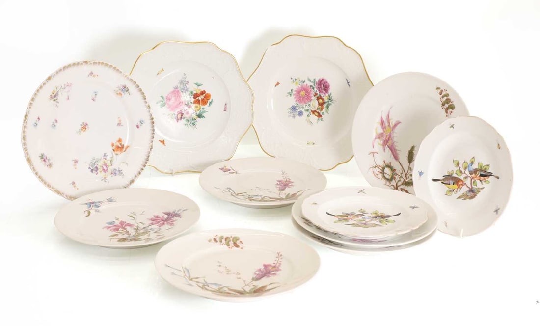 A collection of Continental porcelain plates, 20th century,: A collection of Continental porcelain plates, 20th century, to include two small side plates handpainted with birds and bugs to the rim, bearing blue crossed sword marks to the base, a pair of larger
