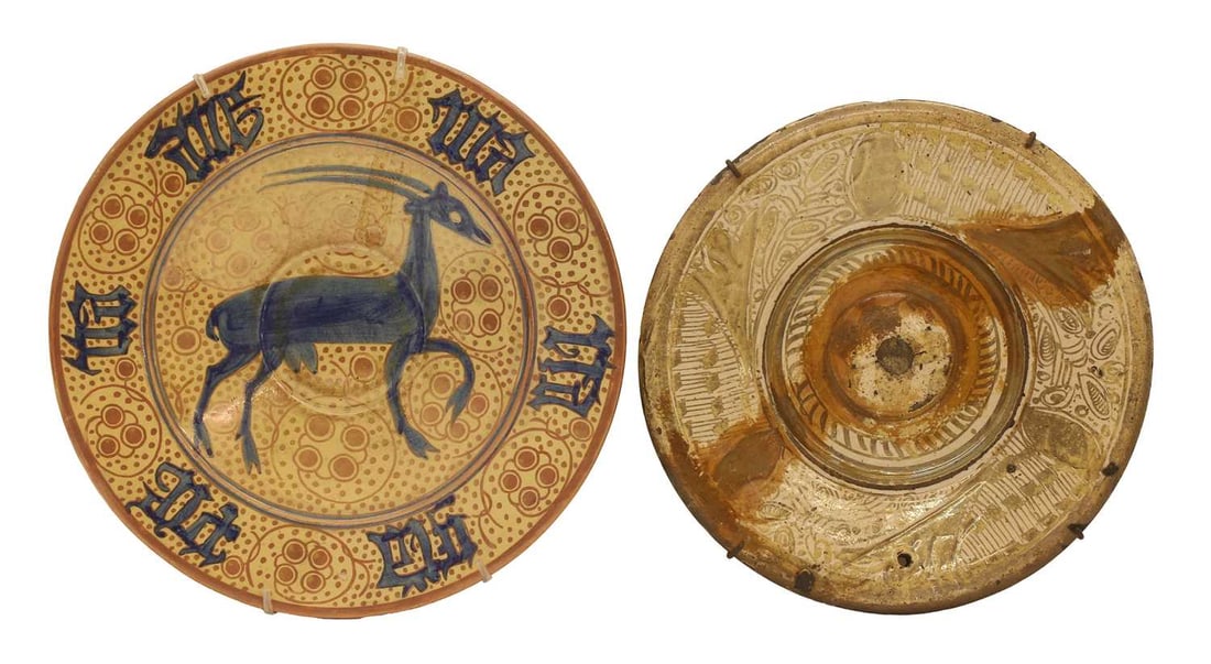 A Hispano-Moresque earthenware lustre dish, 19th century,: A Hispano-Moresque earthenware lustre dish, 19th century, painted in underglaze blue with a stylised stag within a calligraphic border, restored together with a further Hispano-Moresque earthenware