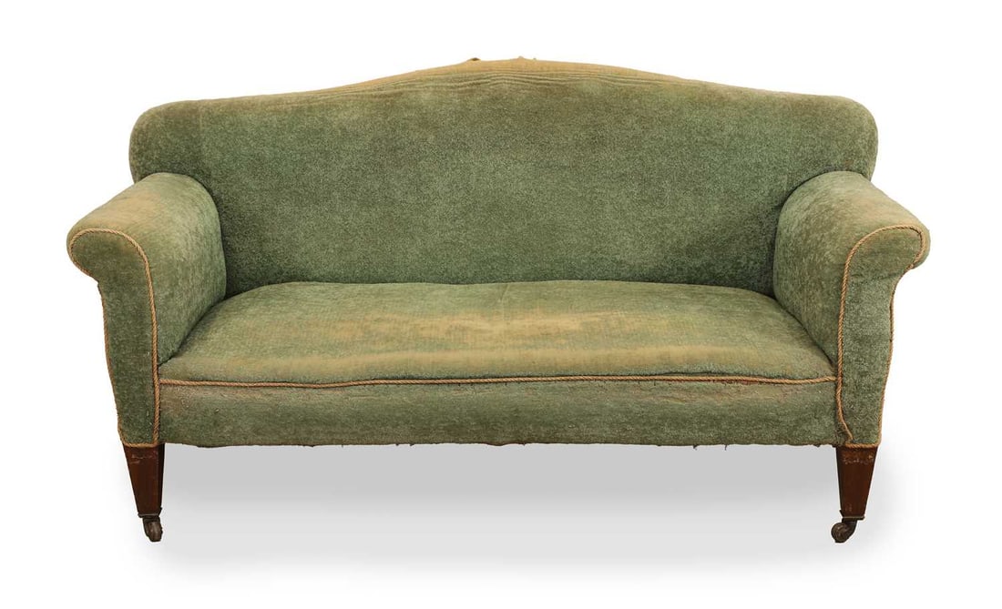 A green upholstered two seater settee, late 19th / 20th century,: A green upholstered two seater settee, late 19th / 20th century, in the manner of Howard and Sons, with rope piping to the scrolling arms, over square tapering legs on brass castors 152cm wide, 82cm