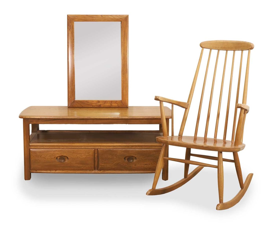 An Ercol Windsor low cabinet, 20th century,: An Ercol Windsor low cabinet, 20th century, having shelf above two base drawers, together with a rocking chair and an Ercol wall mirror Low cabinet, 110cm wide, 45cm deep, 48cm high; Chair, 61cm