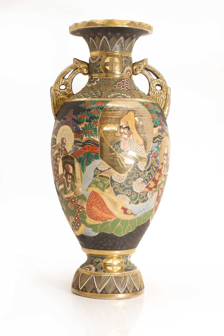 A large Japanese satsuma vase, c.1930,: A large Japanese satsuma vase, c.1930, of urn form with twin pierced handles, raised on a circular foot, painted in polychrome enamels and gilt, decorated with stylised male figures in a garden