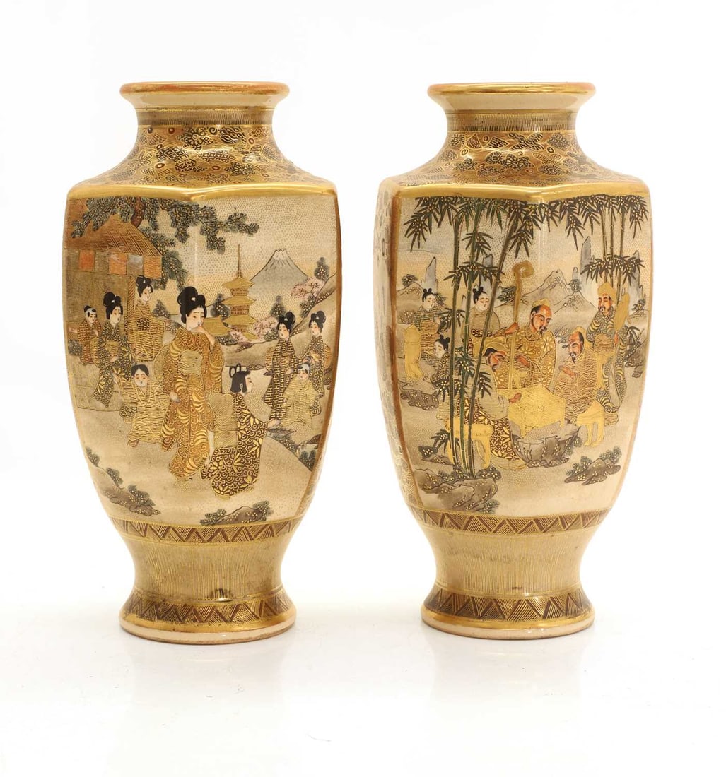 A pair of Japanese satsuma vases, early 20th century,: A pair of Japanese satsuma vases, early 20th century, each of hexagonal form rising from a short circular foot, painted in gilt and enamels depicting a scene of courtly ladies in a garden pavillion,