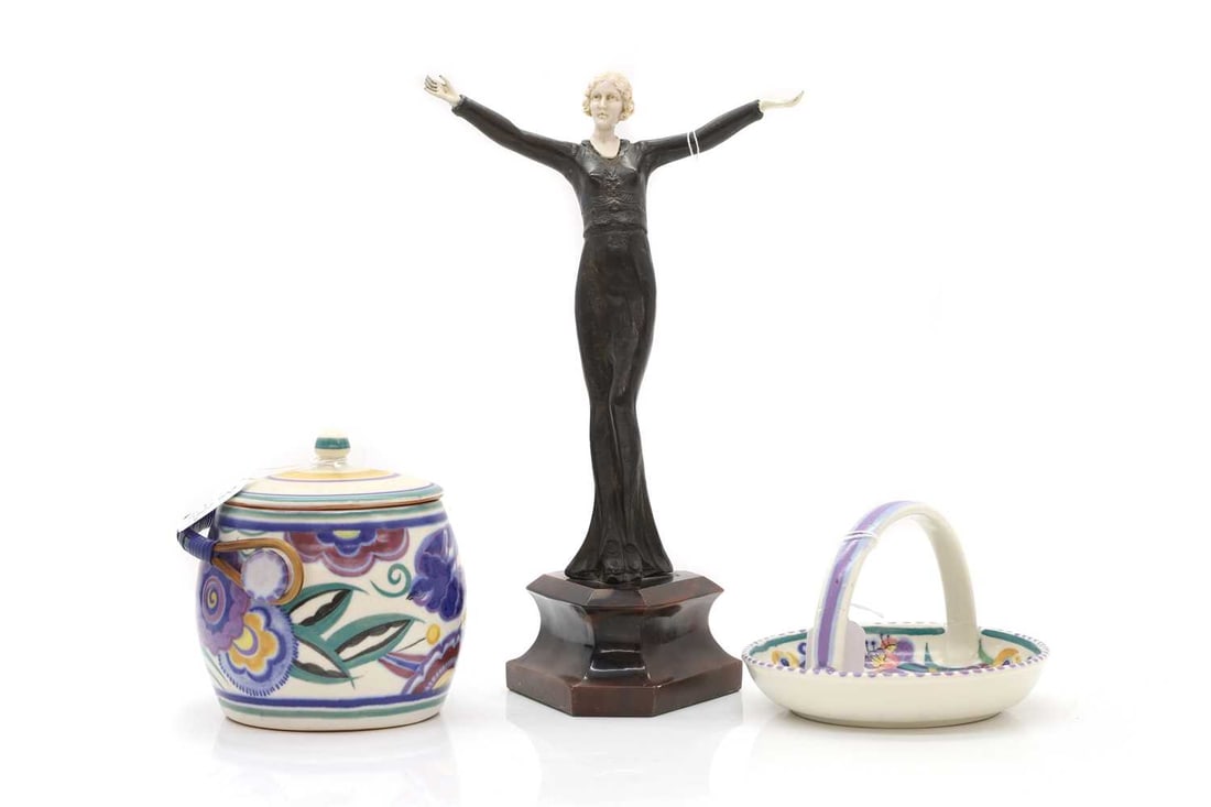 An Art Nouveau bronze and ivorine figurine, early 20th century,: An Art Nouveau bronze and ivorine figurine, early 20th century, modelled as a dancing lady, with cold painted hands, on faux marble base, together with two pieces of Poole Pottery Ivory Declaration