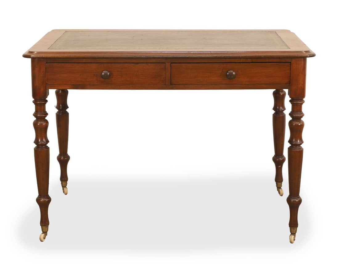 A Victorian mahogany leather writing table/desk, early 20th century,: A Victorian mahogany leather writing table/desk, early 20th century, with an inset leather writing surface and finely turned legs, with two drawers and terminating with ceramic castors 105cm wide, 67c
